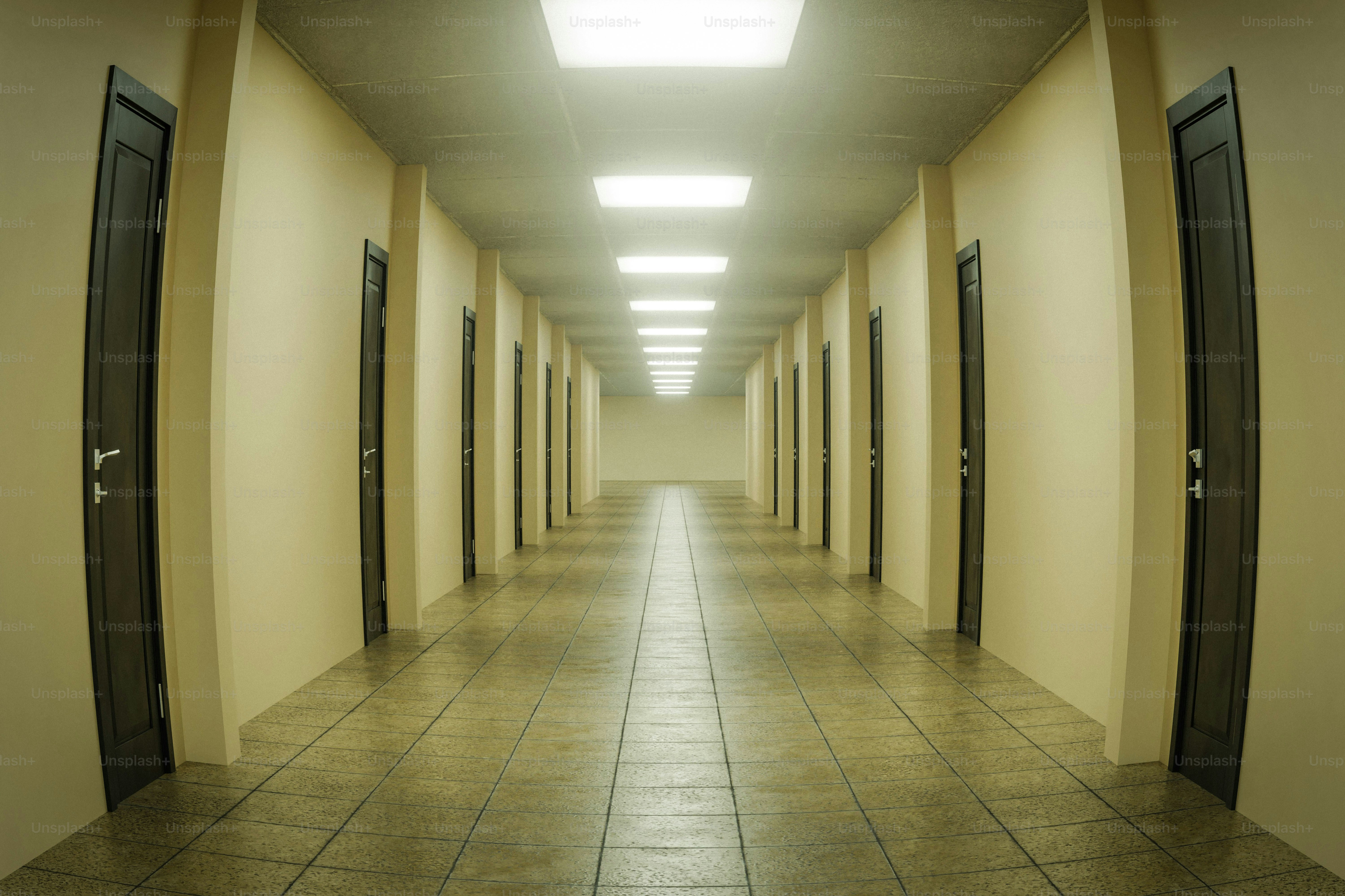 Long empty corridor with doors and bright overhead lights