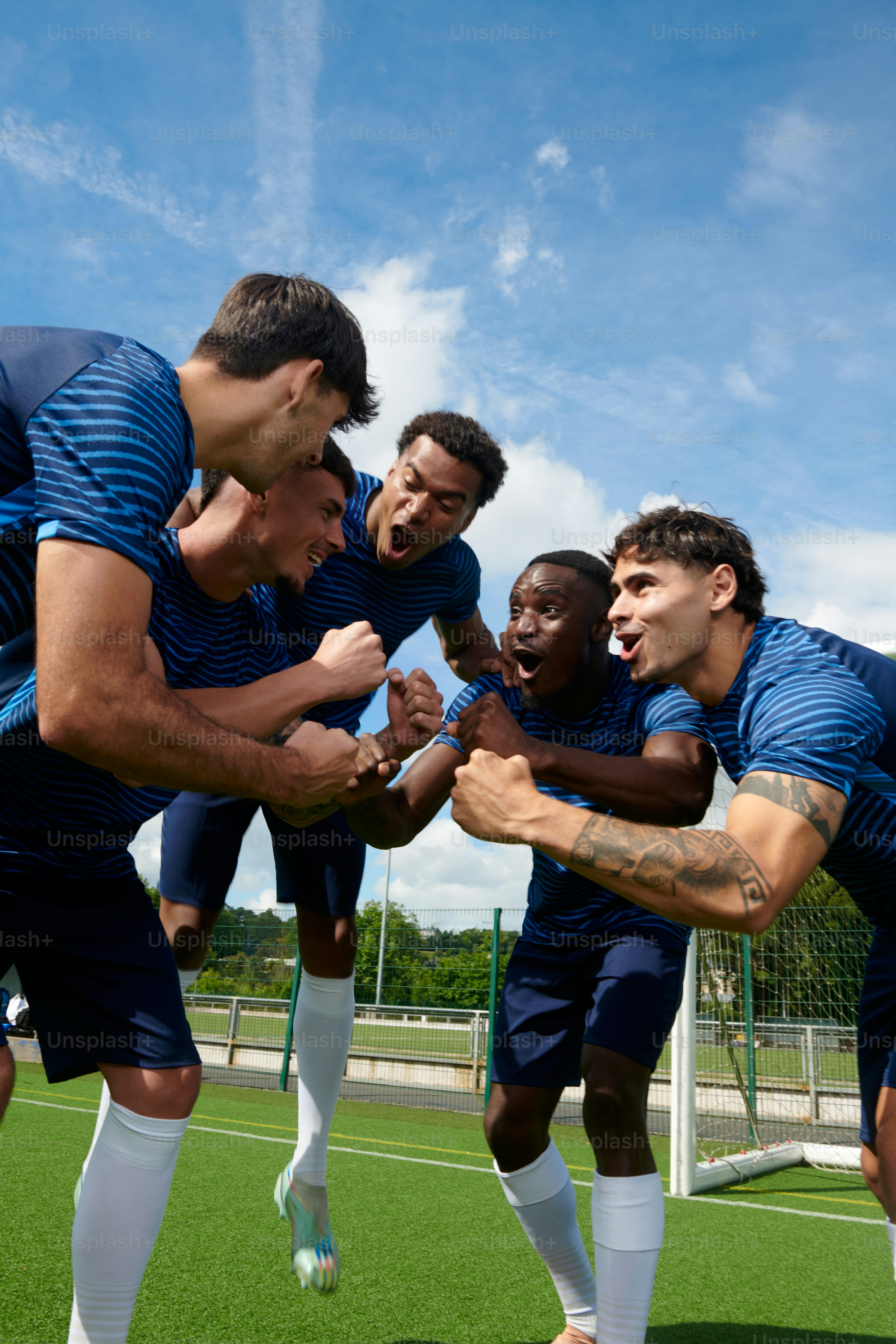 Five soccer players resting on a dugout bench photo – Football Image on ...