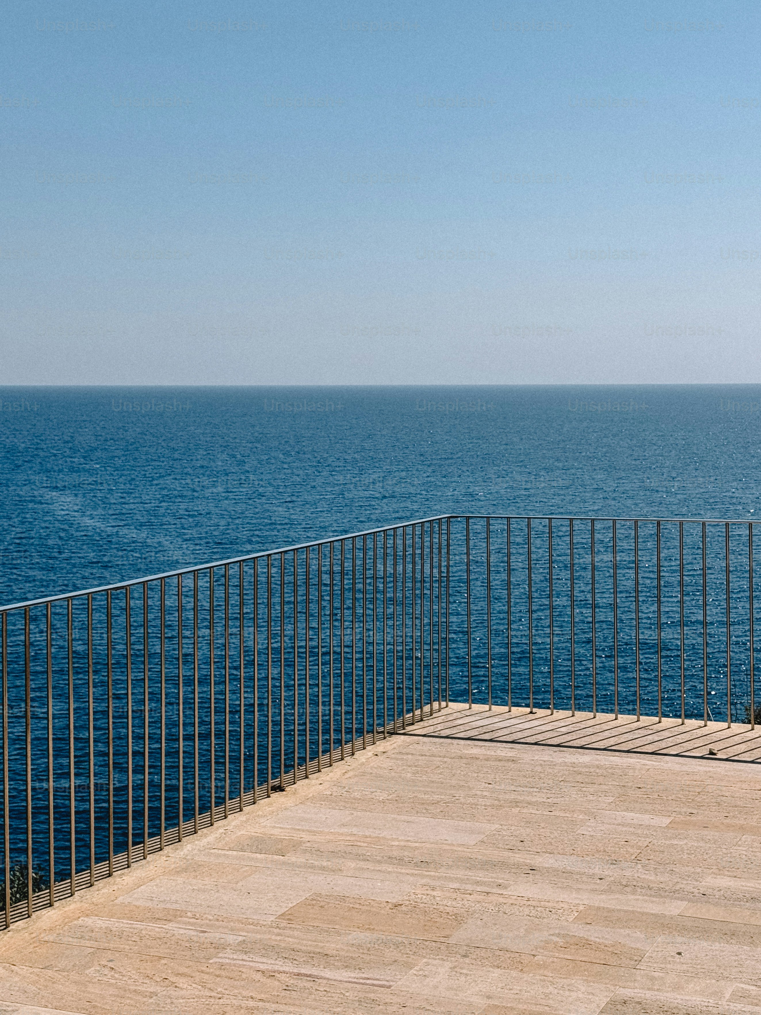 Balcony with metal railing overlooking blue ocean