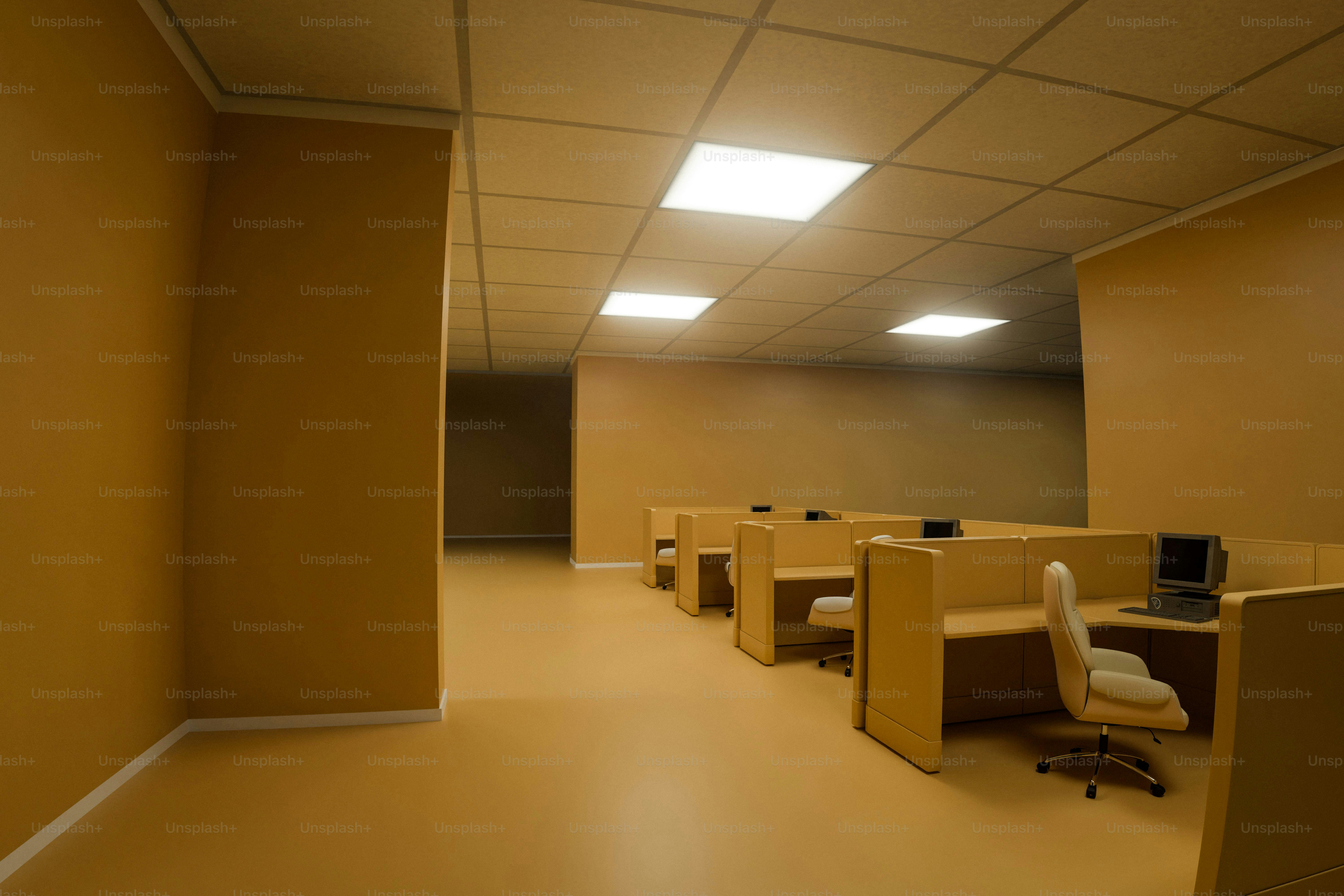 Empty office cubicles under fluorescent ceiling lights