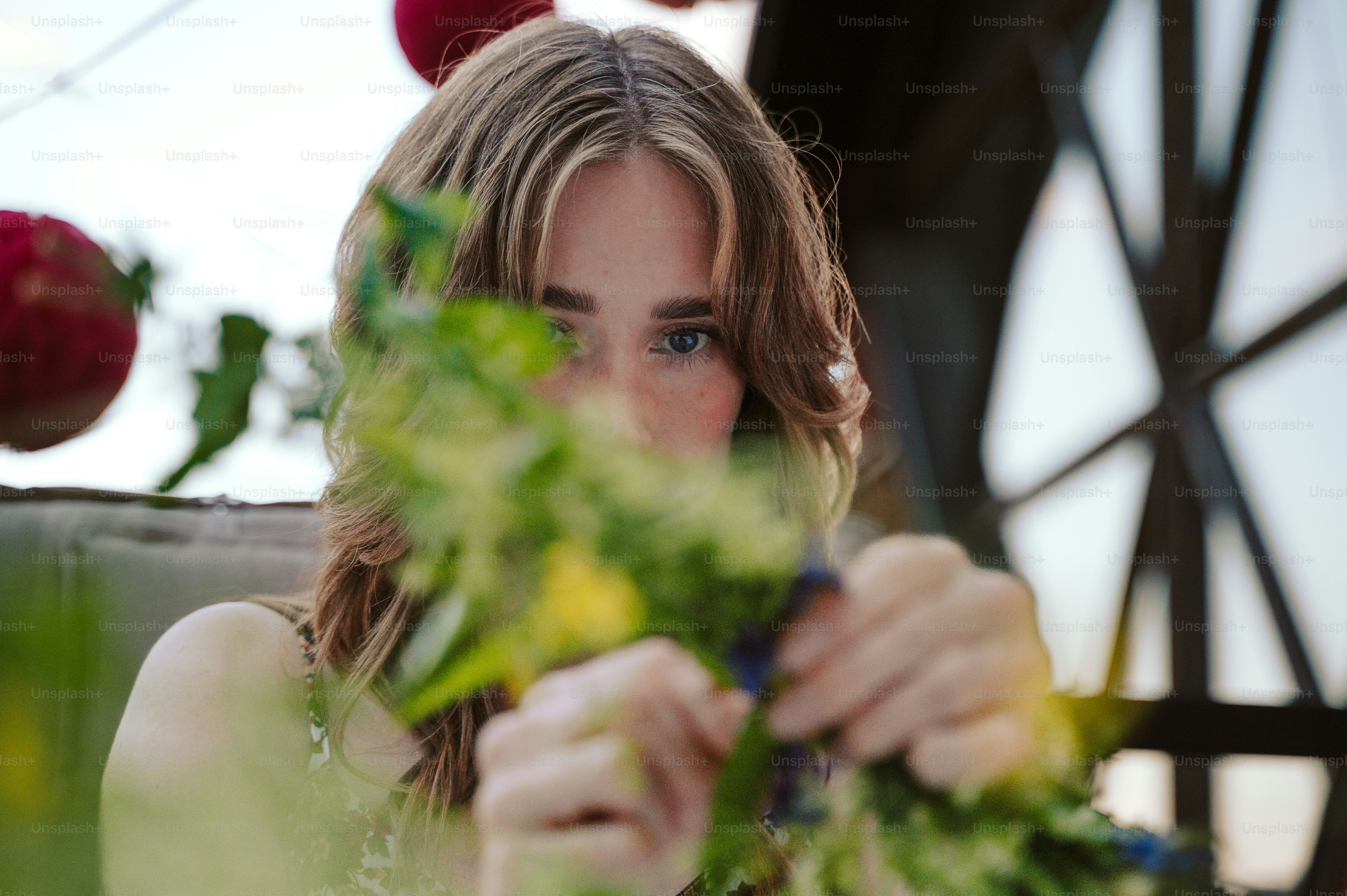 Woman making a wildflower crown for midsummer