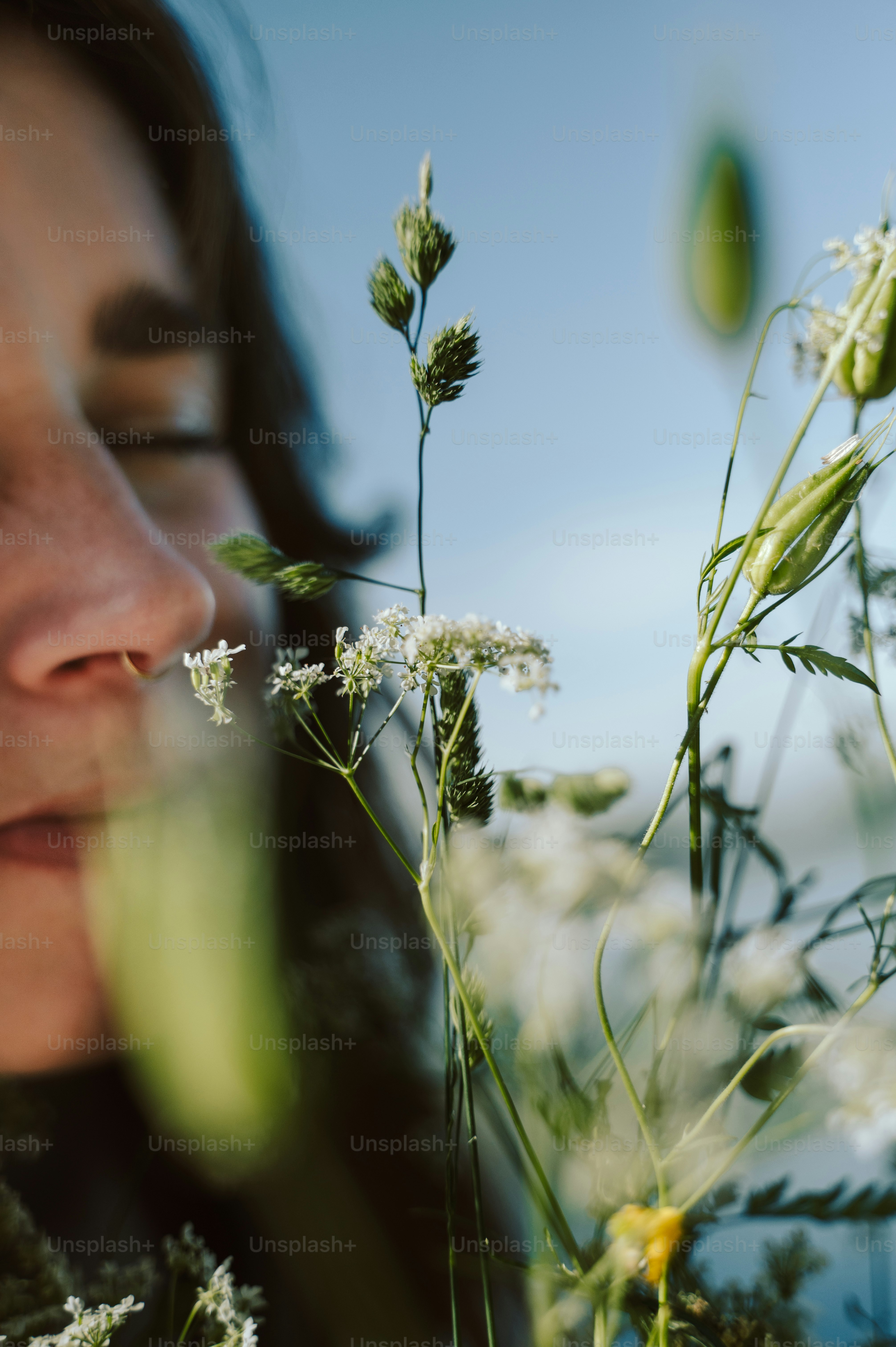 Woman with closed eyes among wildflowers