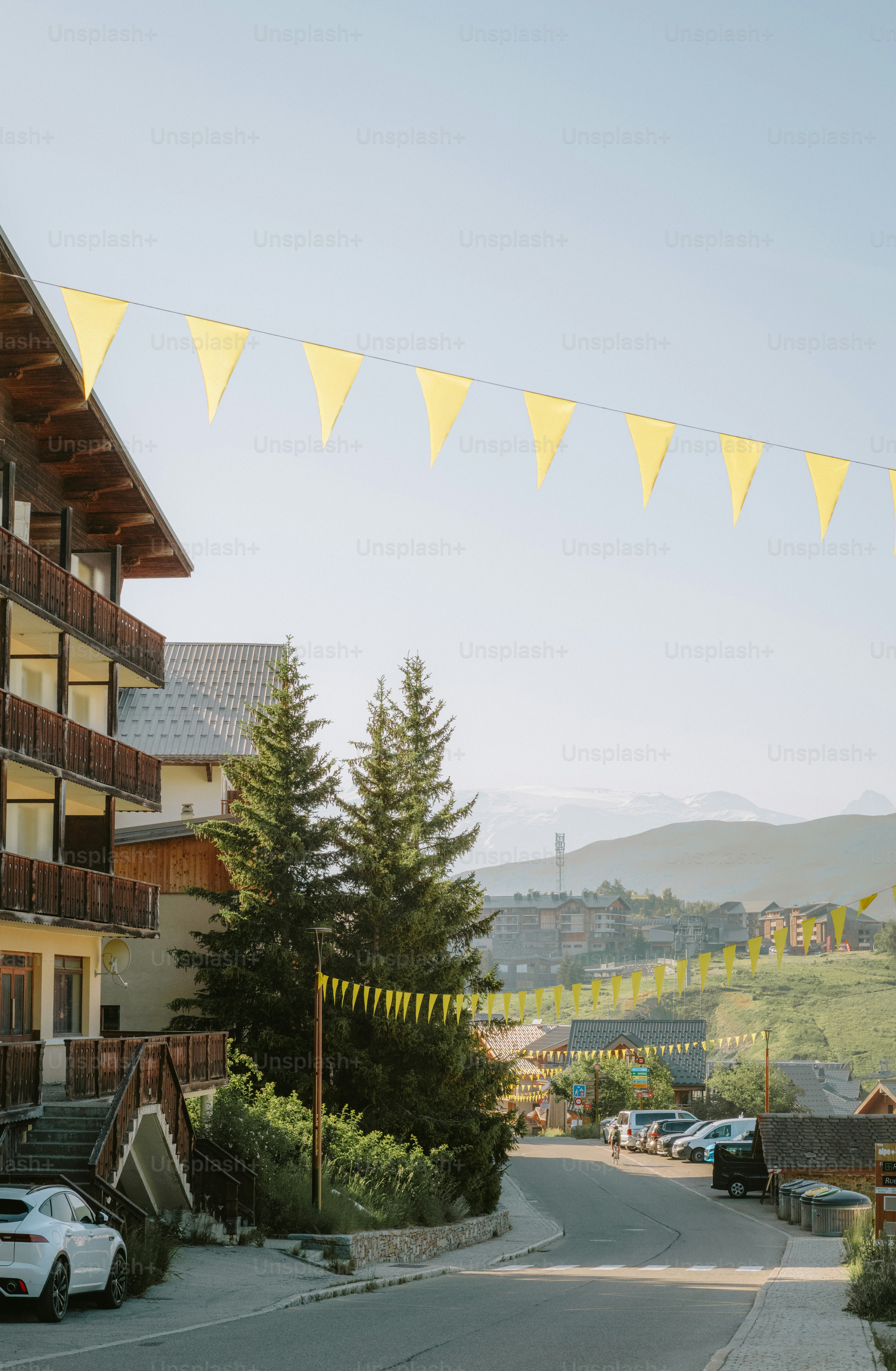 Alpine village road decorated with yellow flags