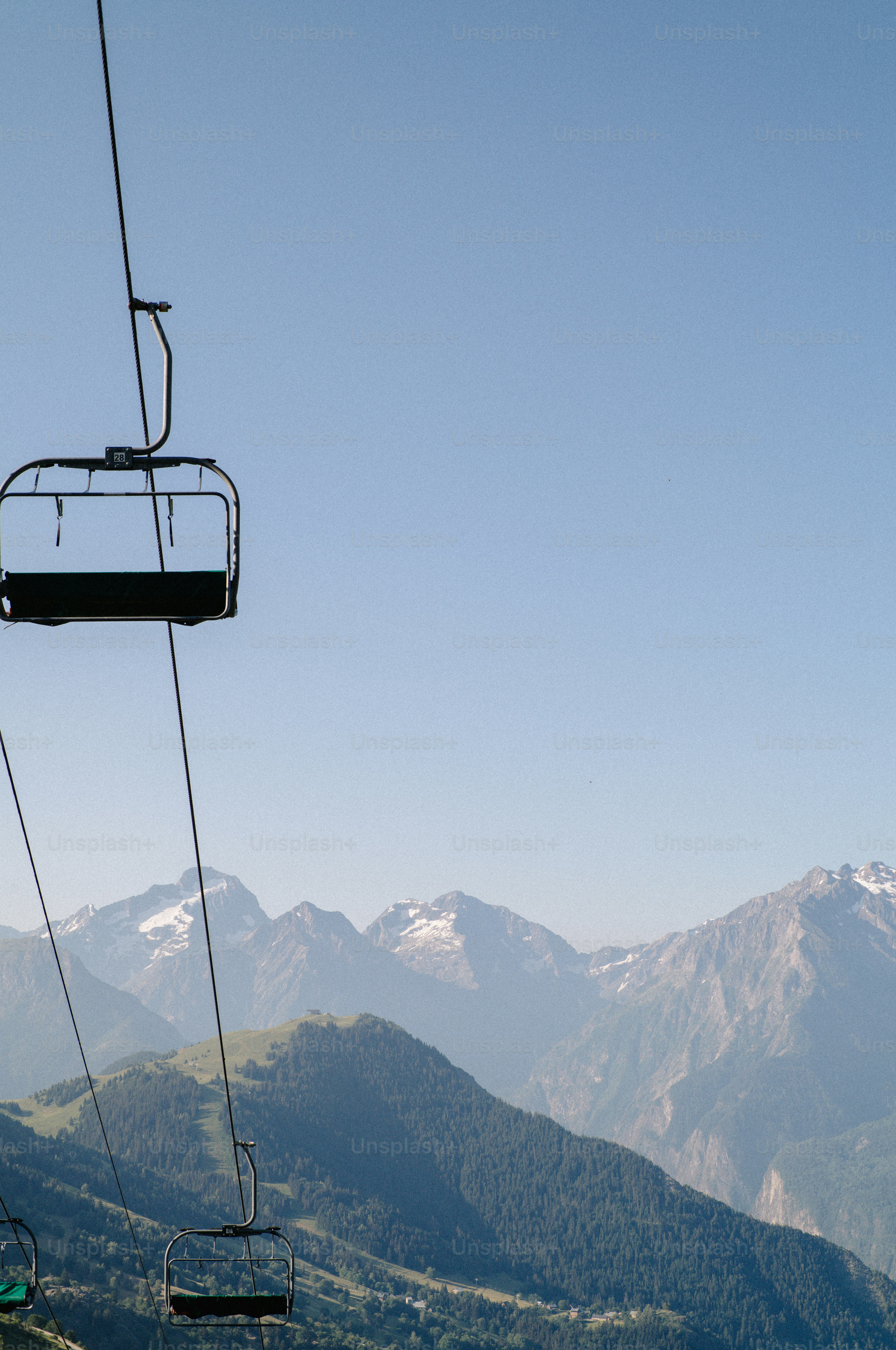 Empty chairlifts ascending over a mountain range