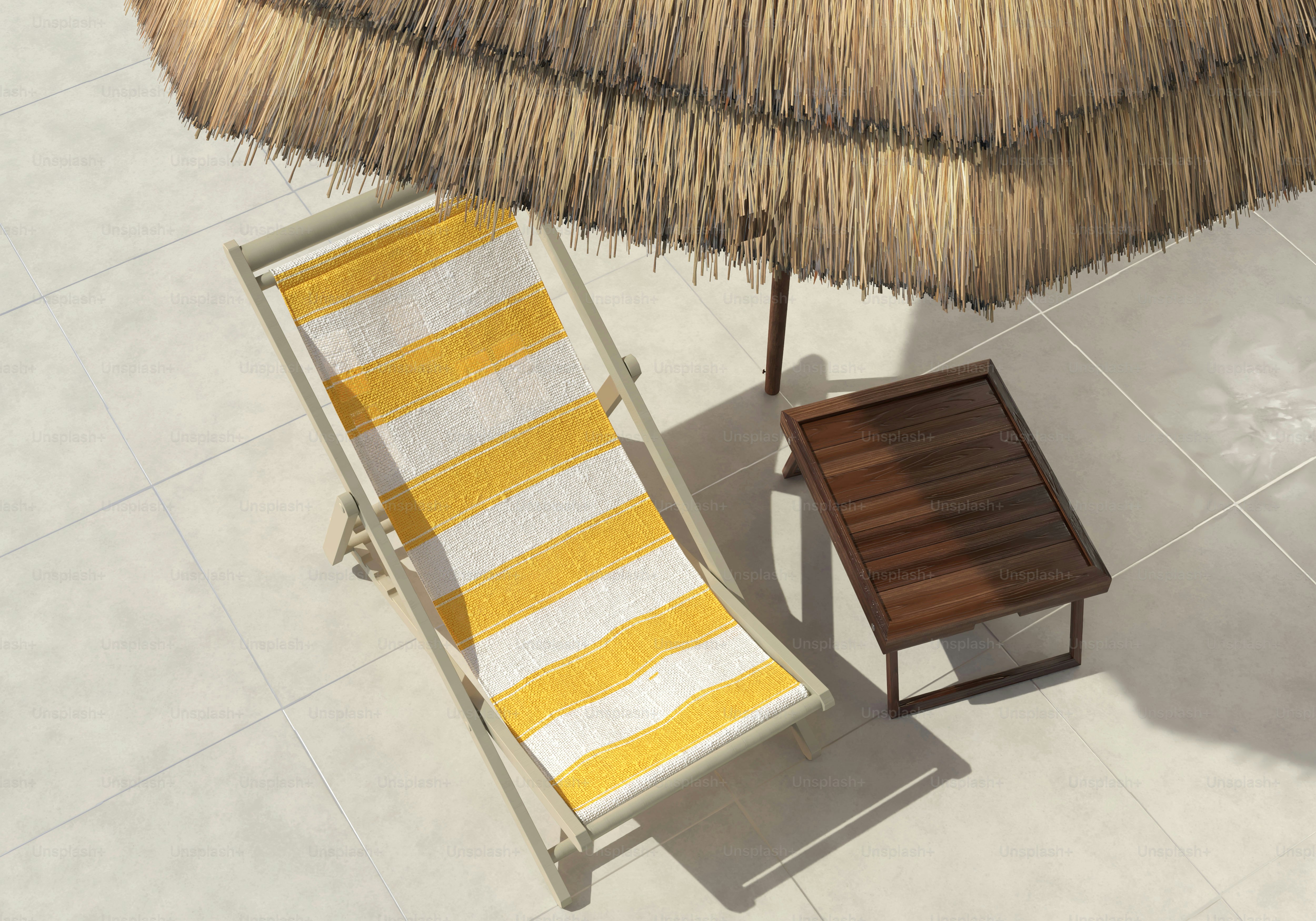 Lounge chair under straw umbrella with small table