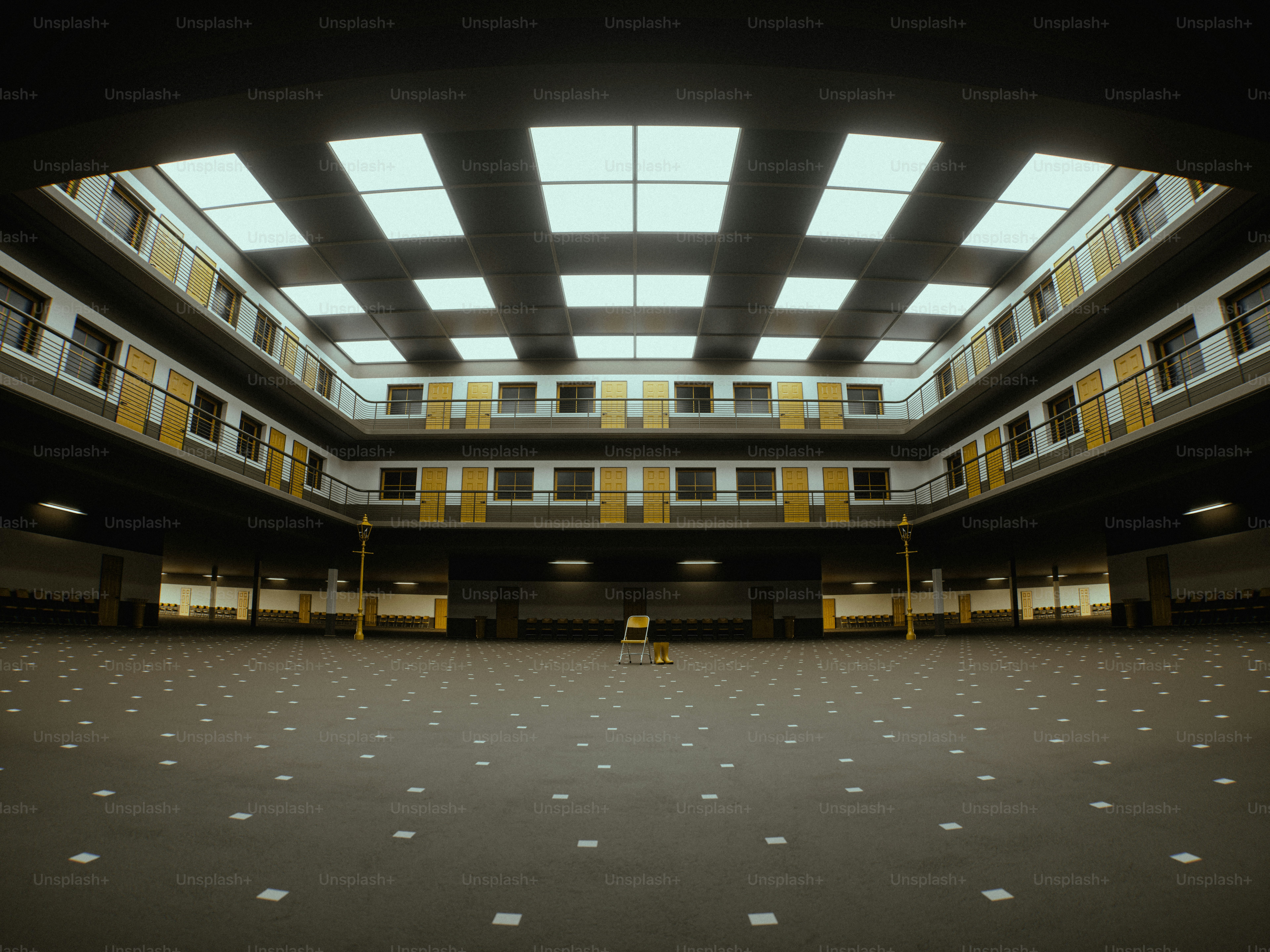 Empty multi-level atrium with central chair and skylights