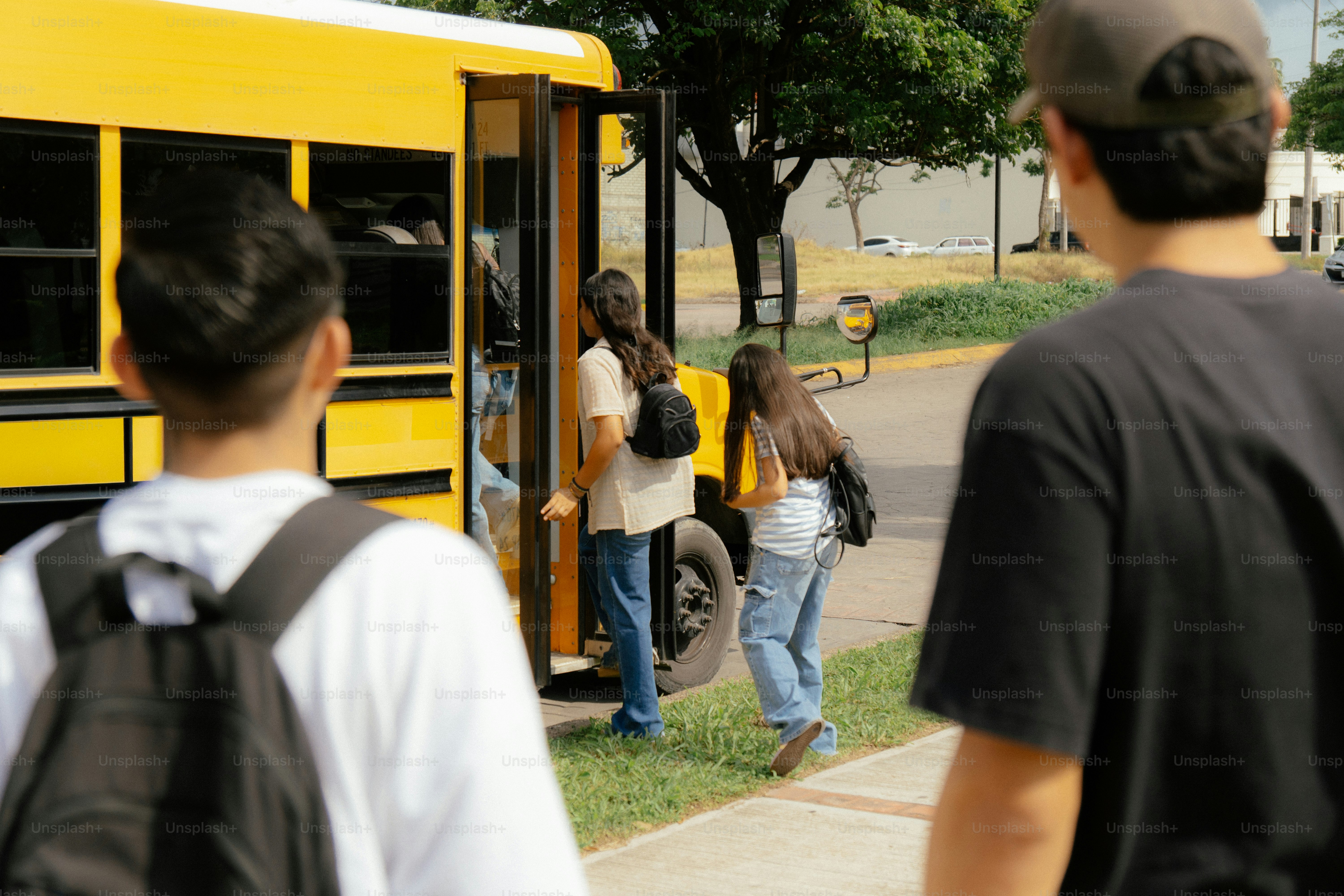 Young students boarding a yellow school bus