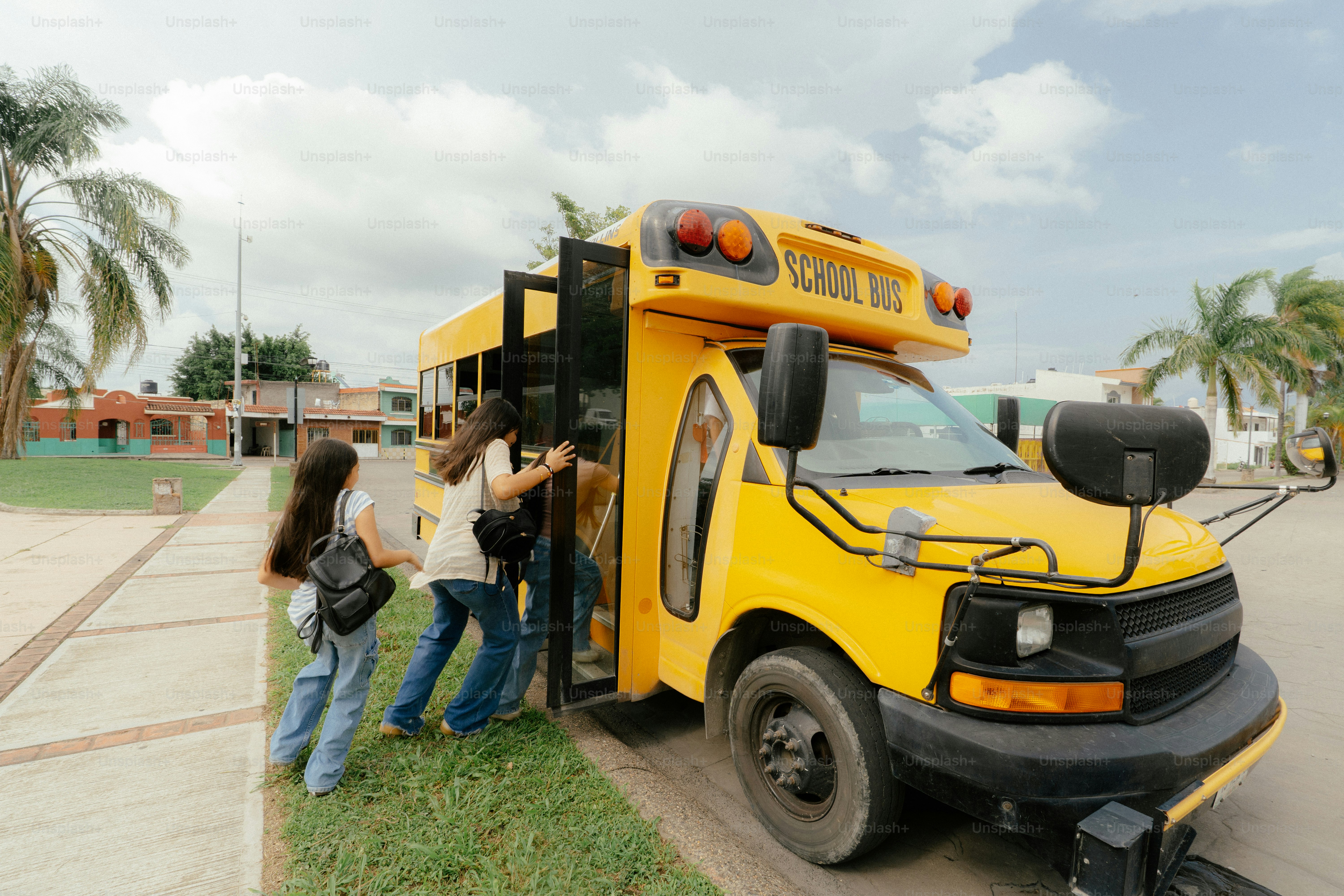 Students boarding a yellow school bus