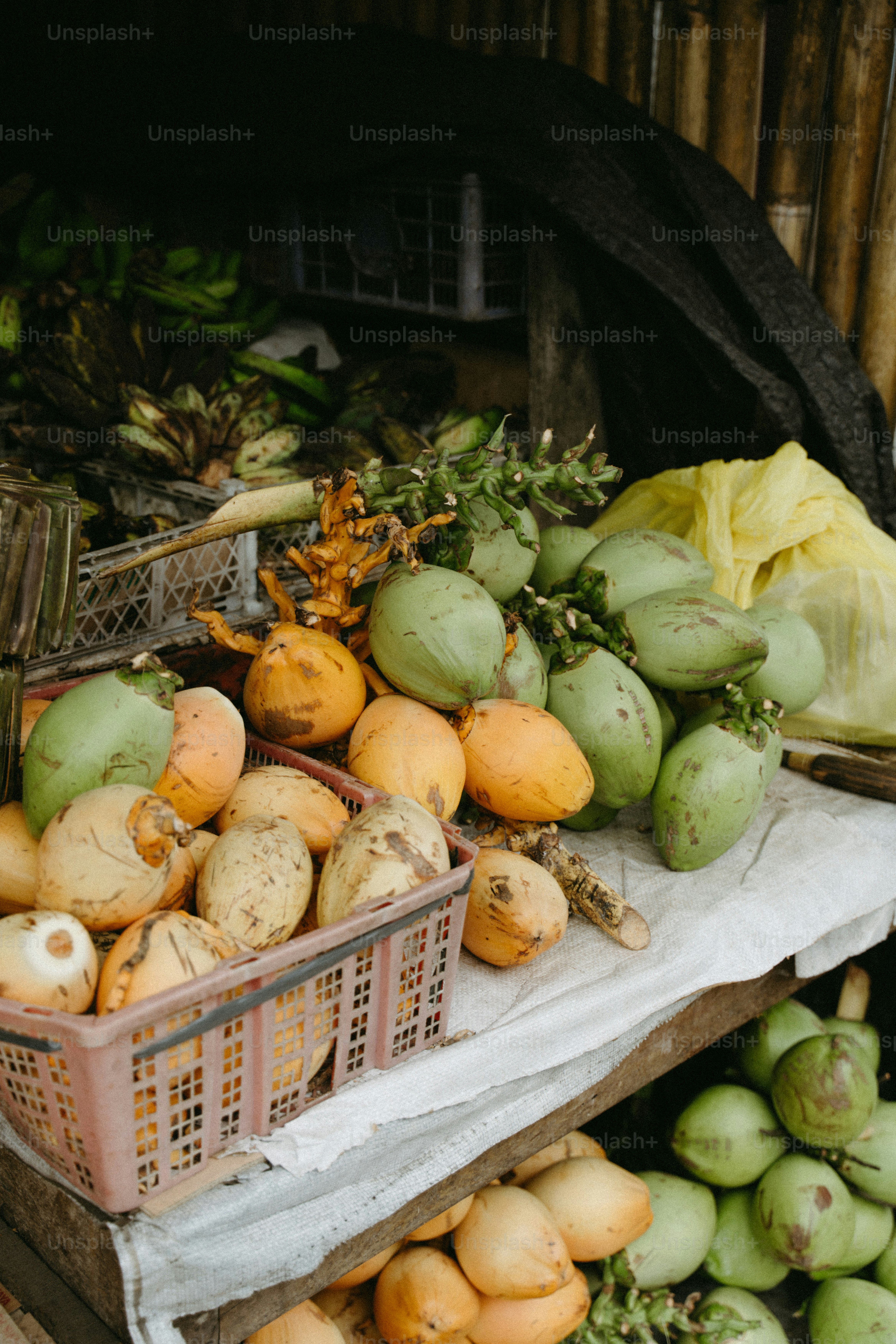Coconuts and other produce at market stall