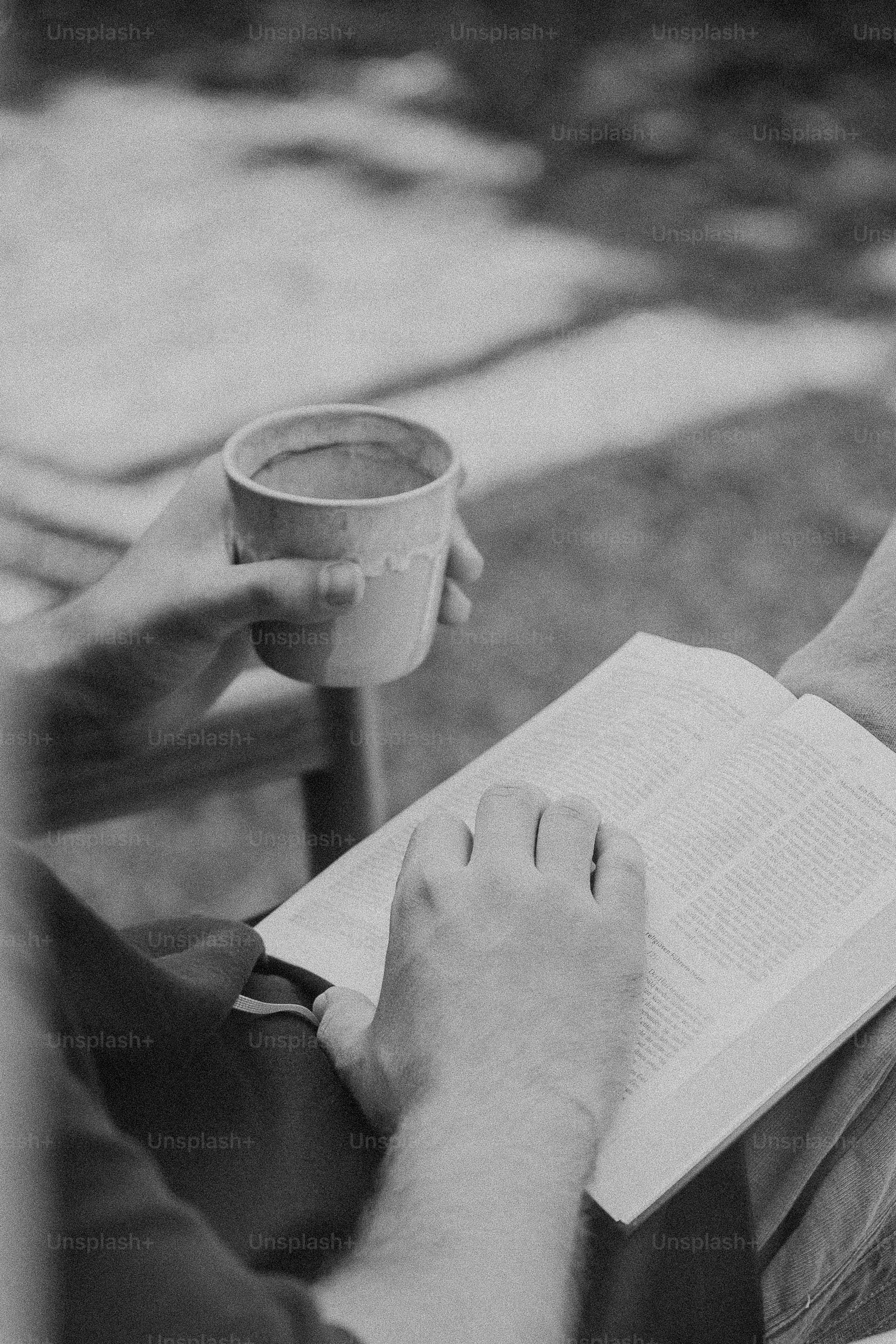 Hands holding bible and cup