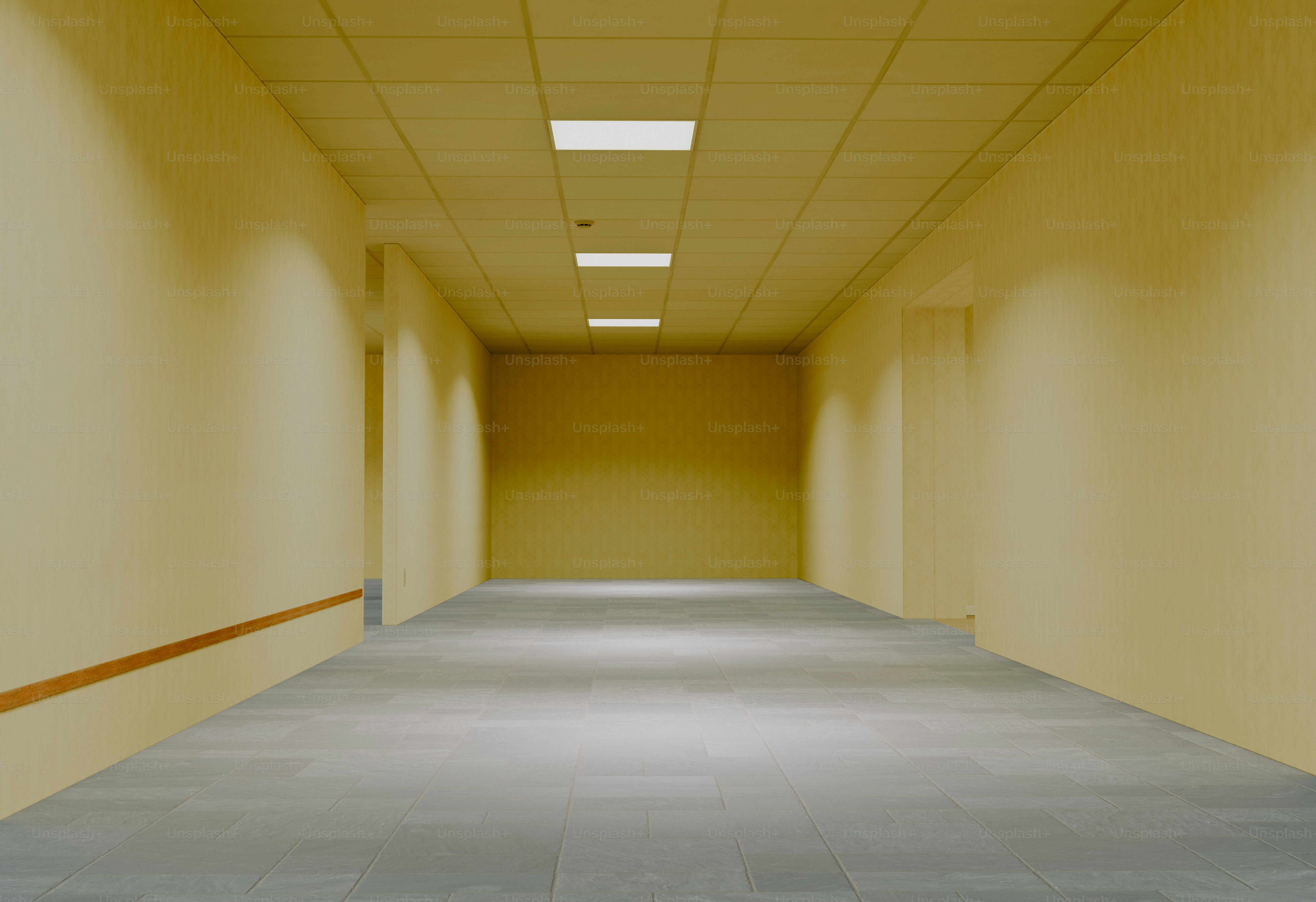 Empty yellow hallway with overhead lights