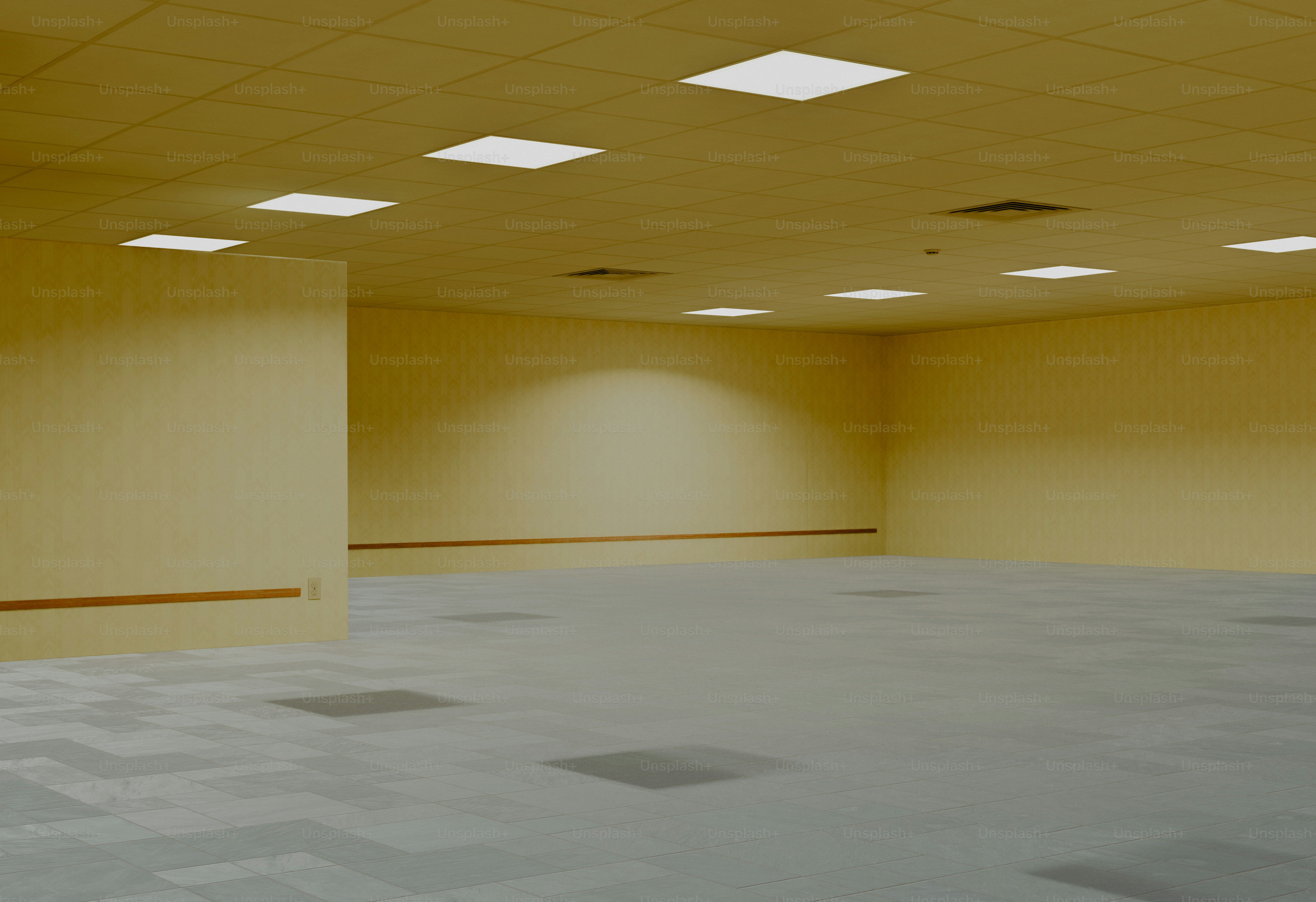 Empty room with yellow walls and patterned carpet