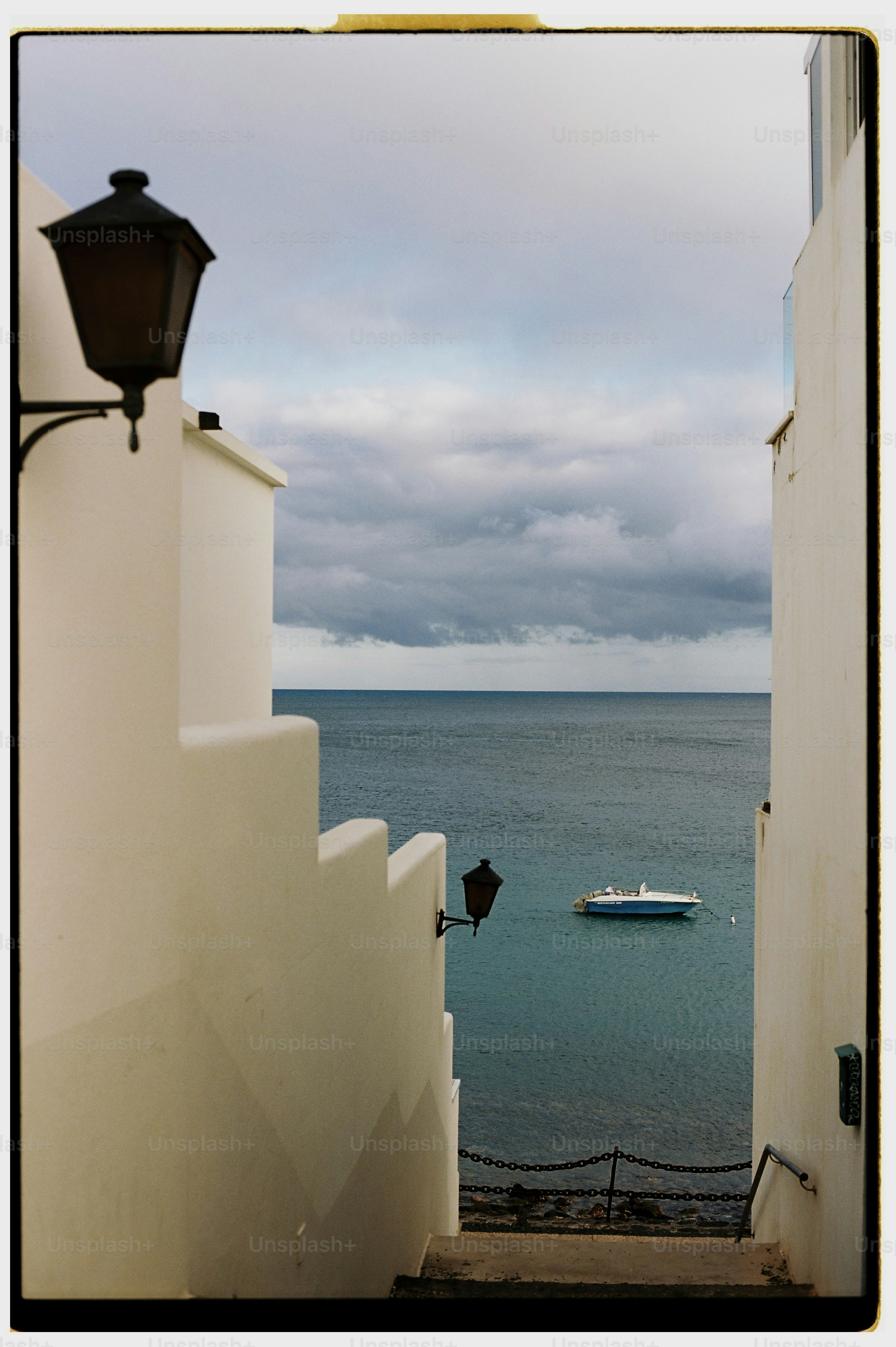Staircase leading to ocean with boat