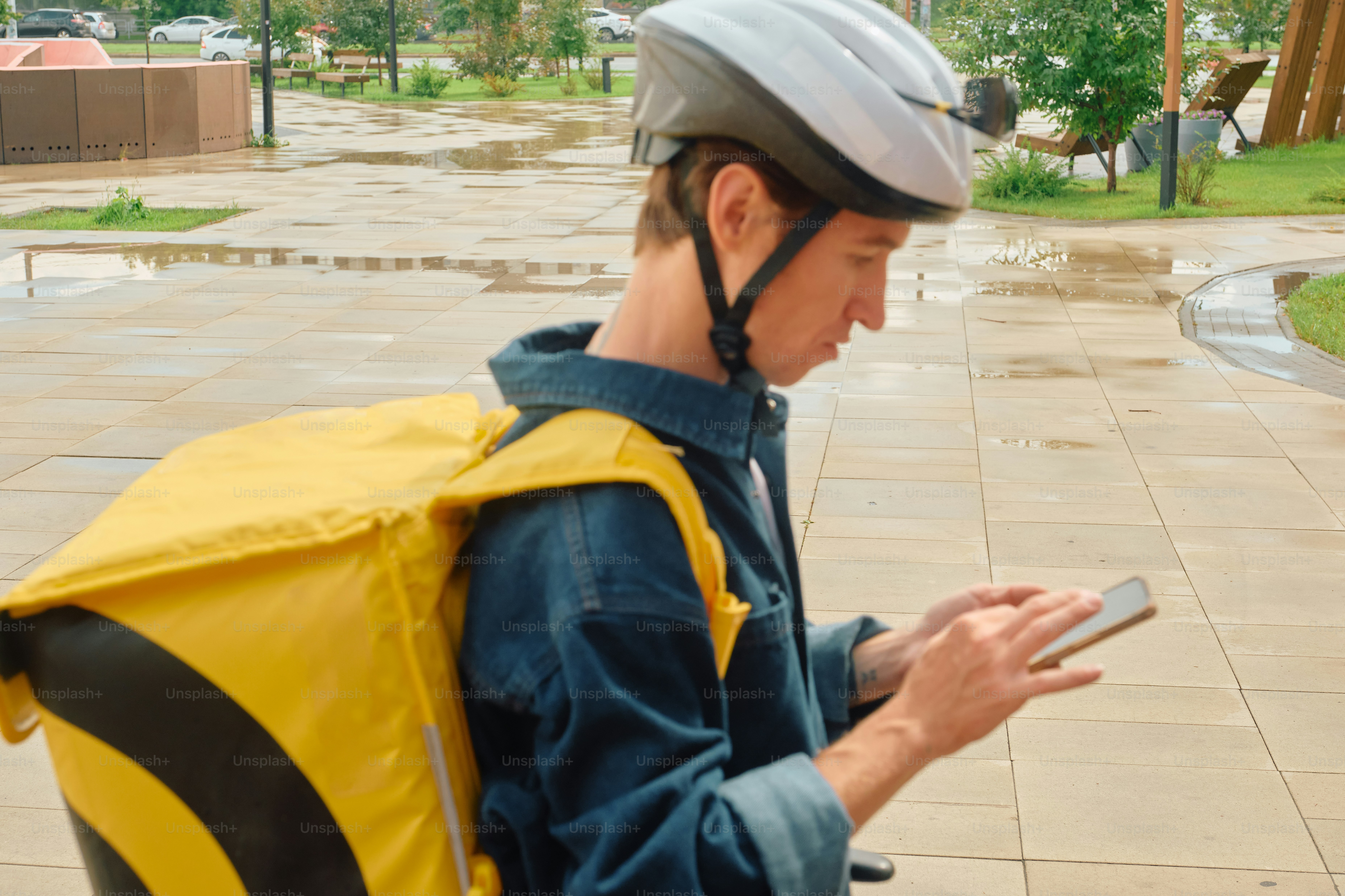 Food delivery rider looking at smartphone