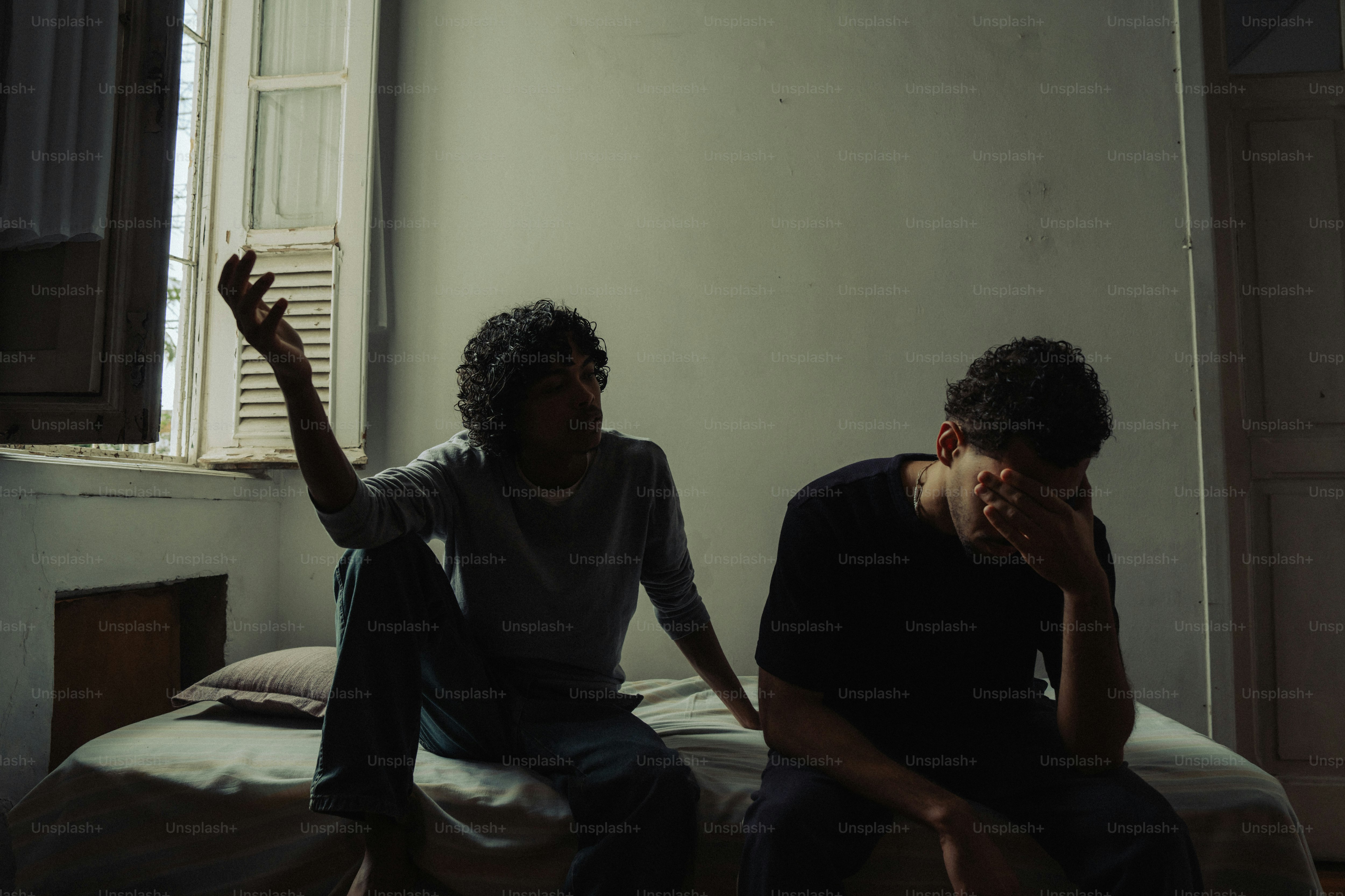 Tense conversation between two people in dim light