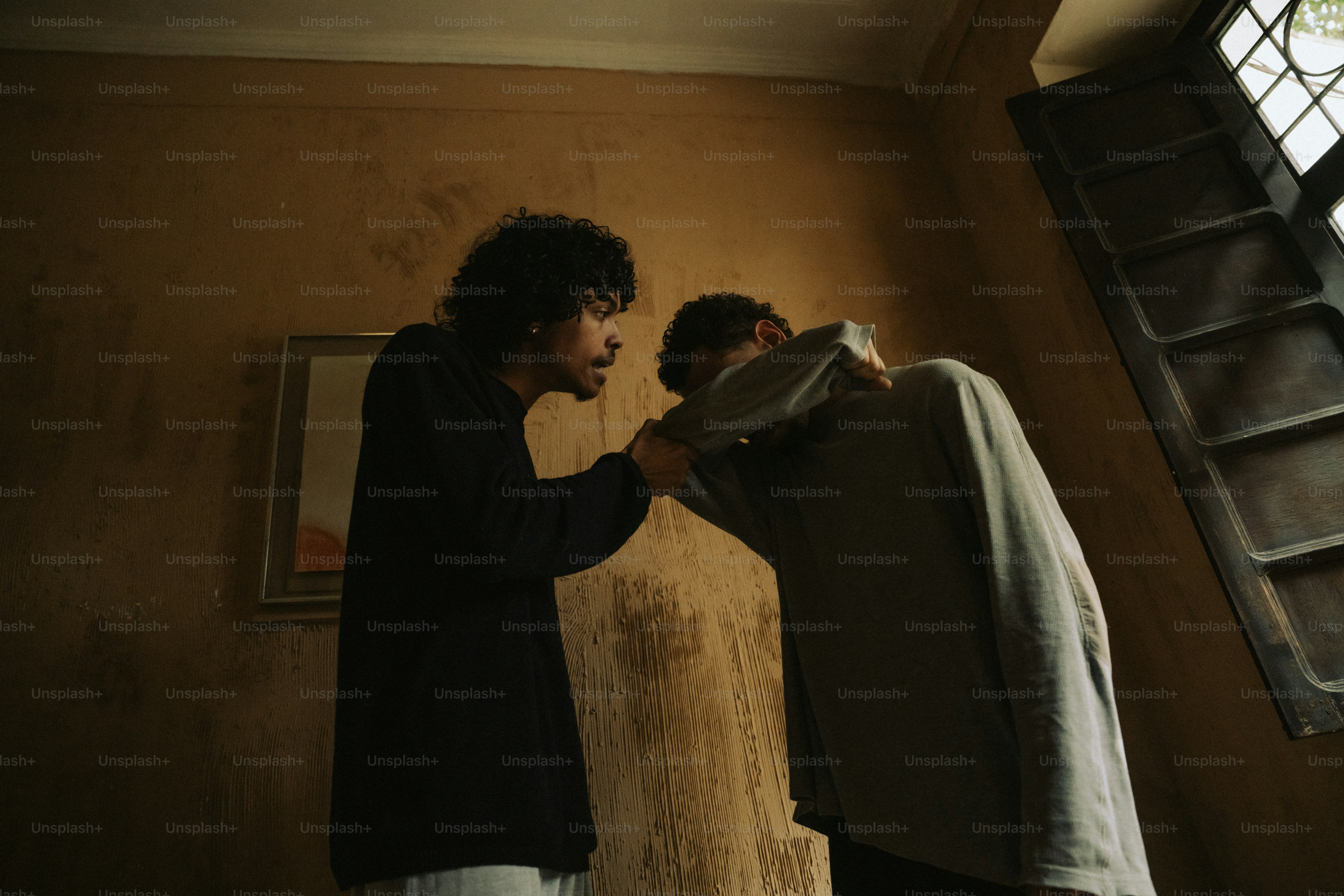 Person grabbing another by the hoodie