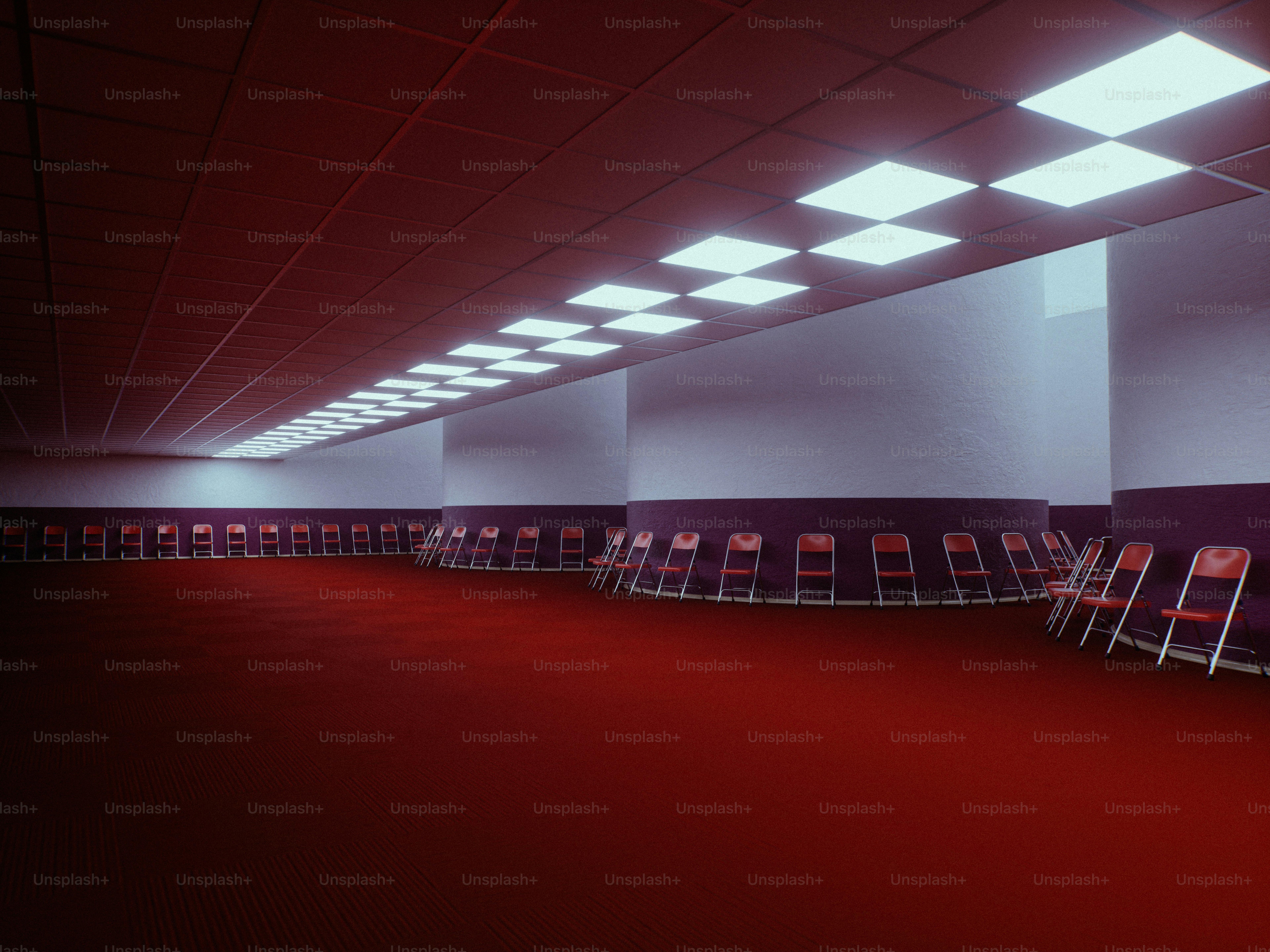 Red carpeted hall with rows of empty chairs
