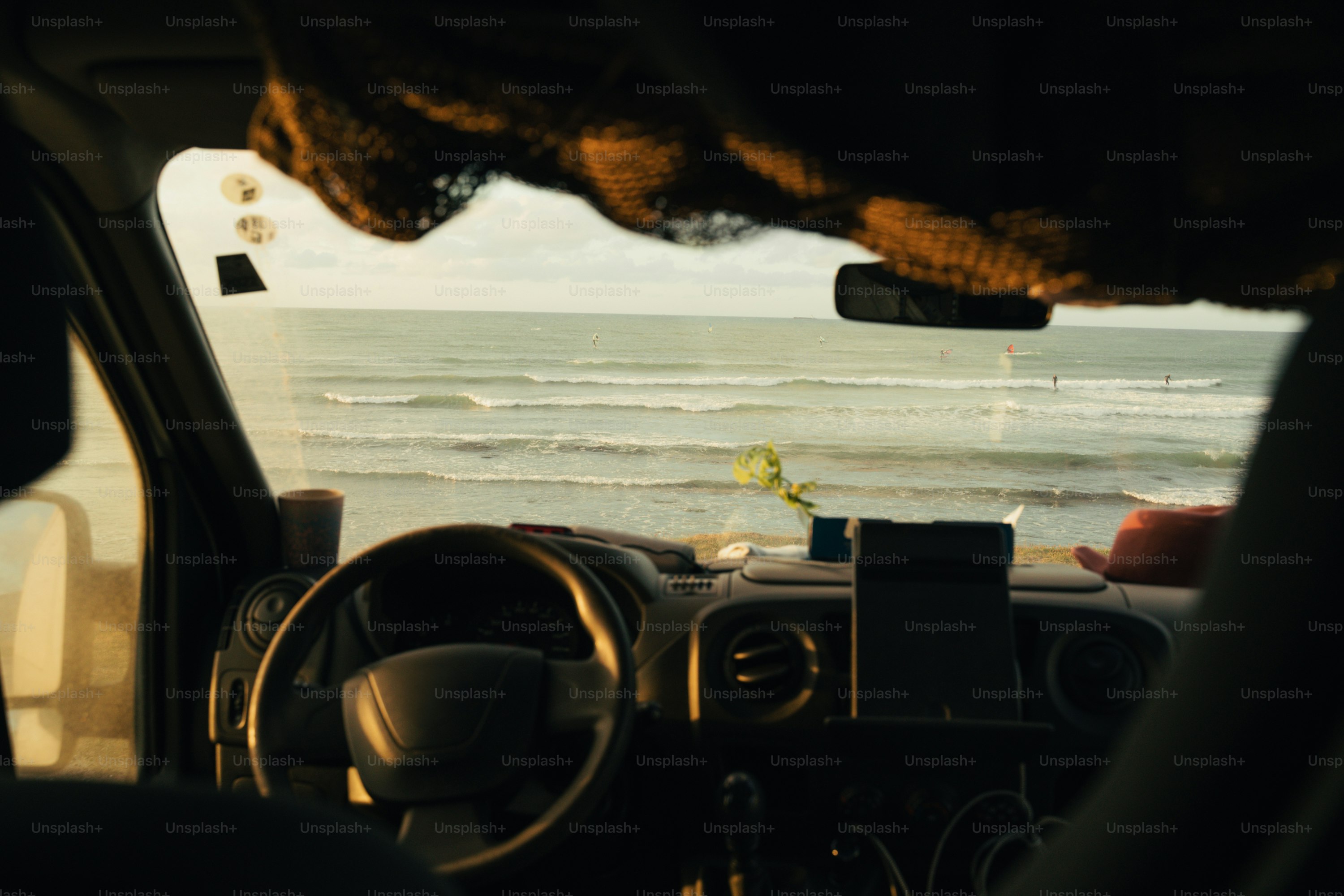 Ocean waves visible from vehicle dashboard