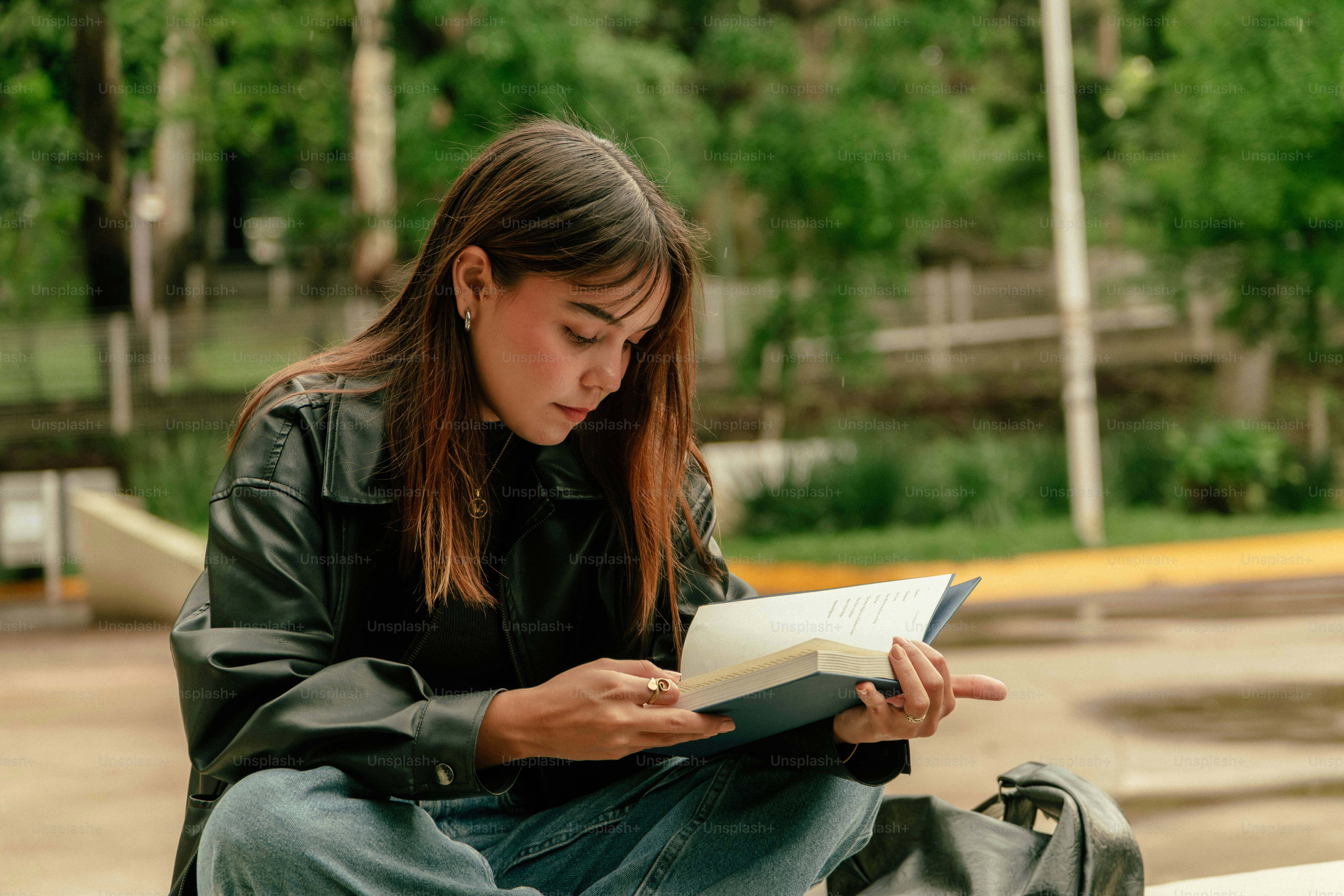 Young woman reading a book outdoors