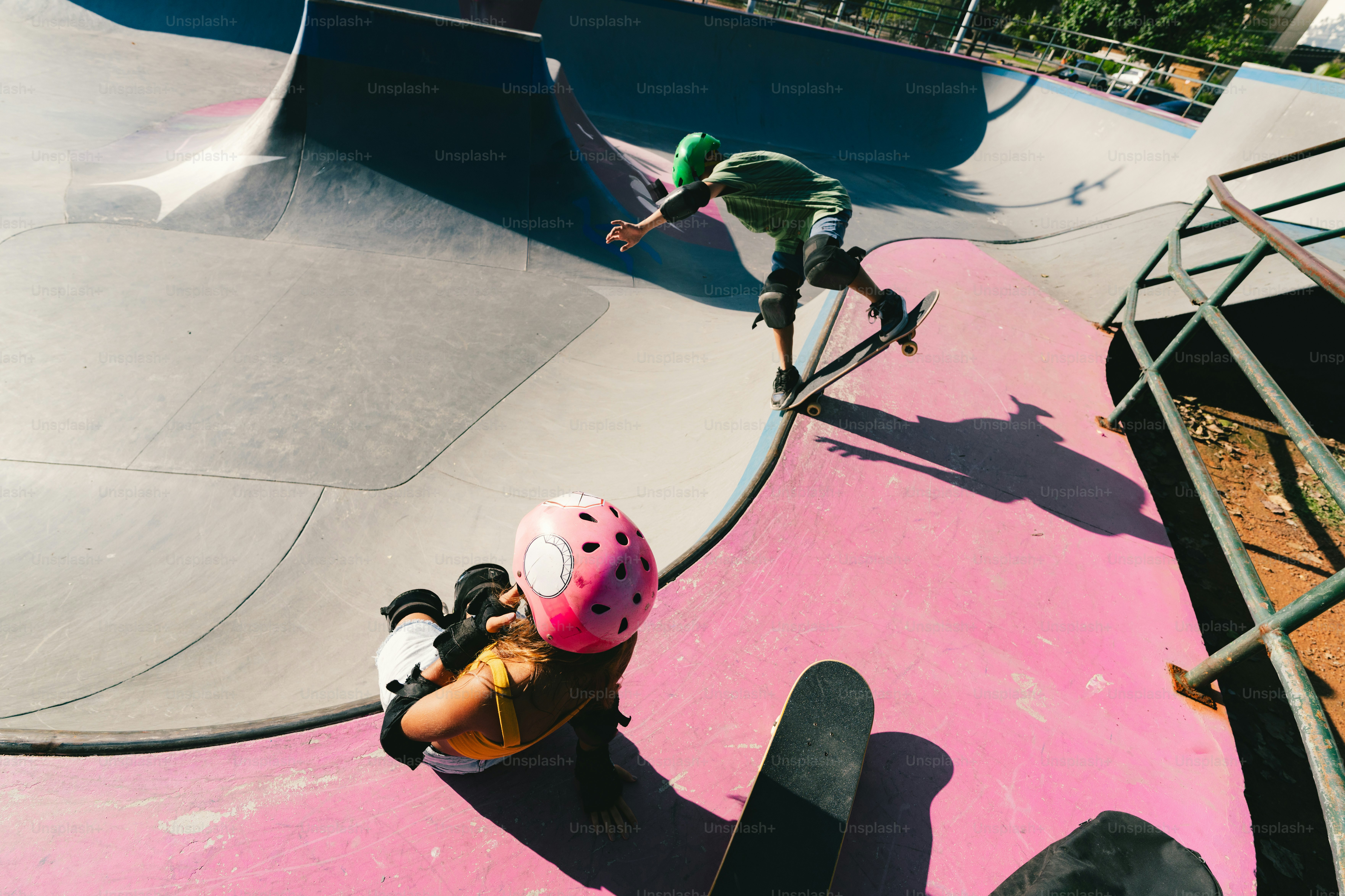 Two people skateboarding in a colorful skatepark