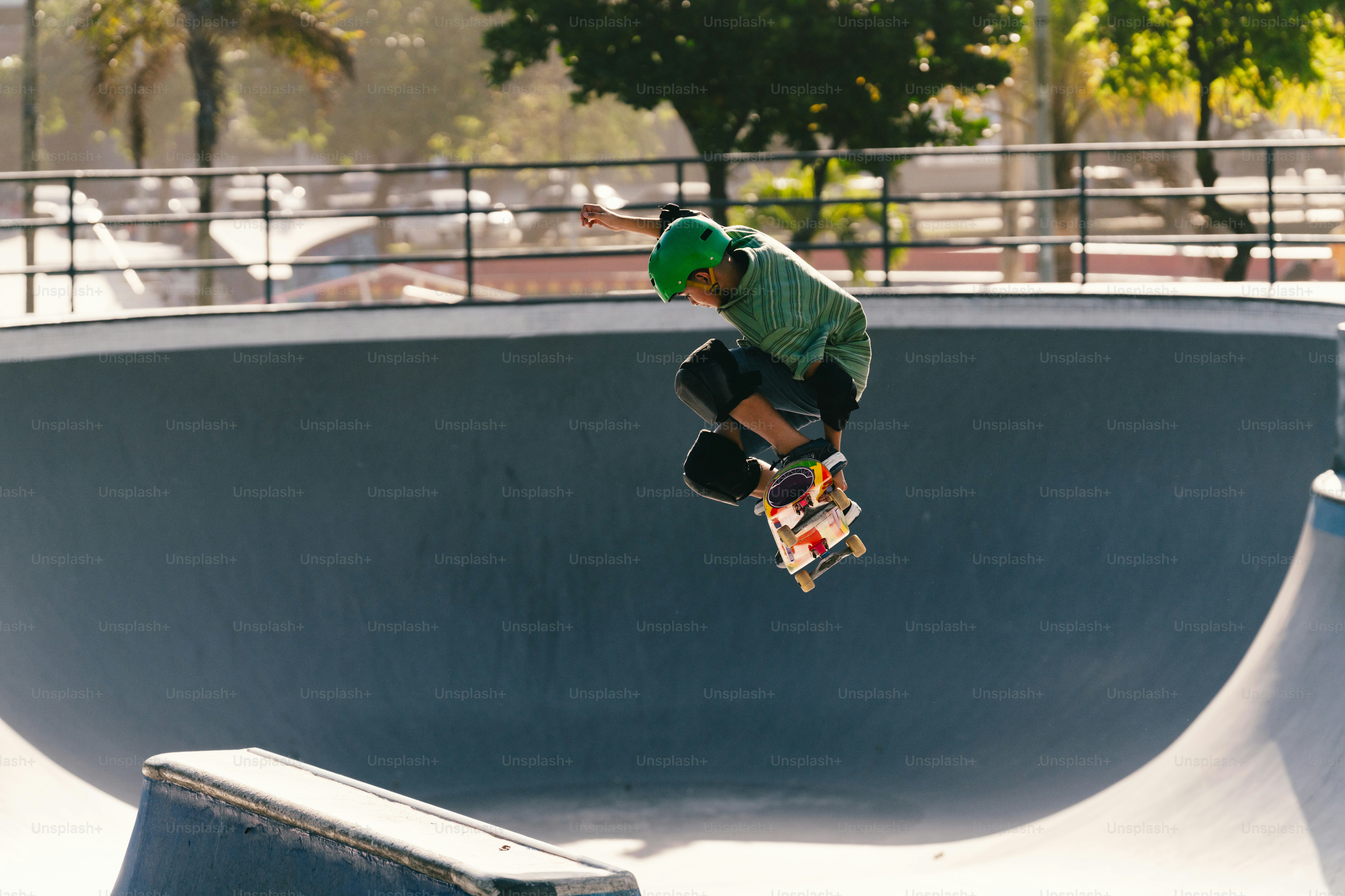 Skateboarder in green hoodie performing aerial trick