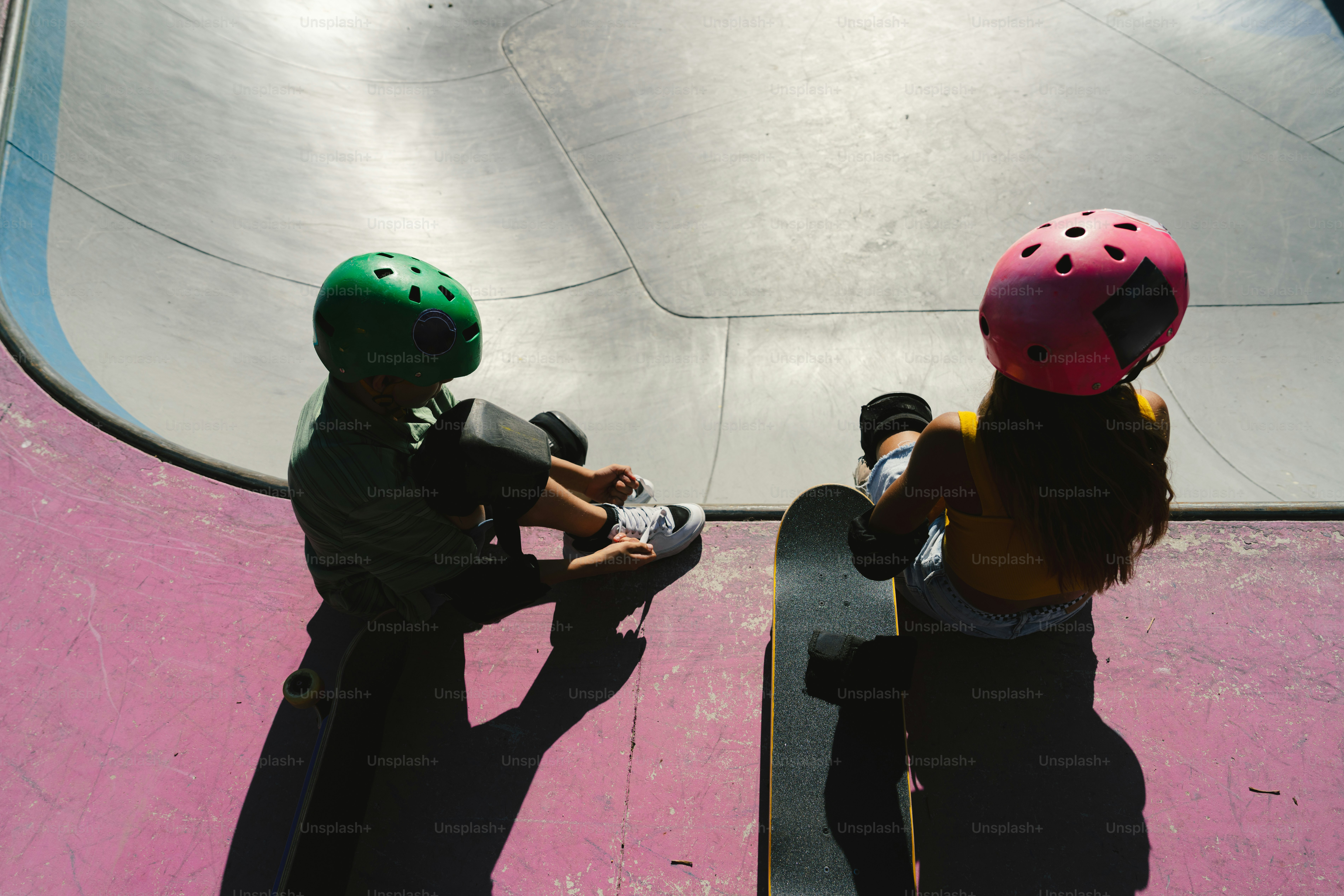 Skaters with helmets and skateboard at skate park