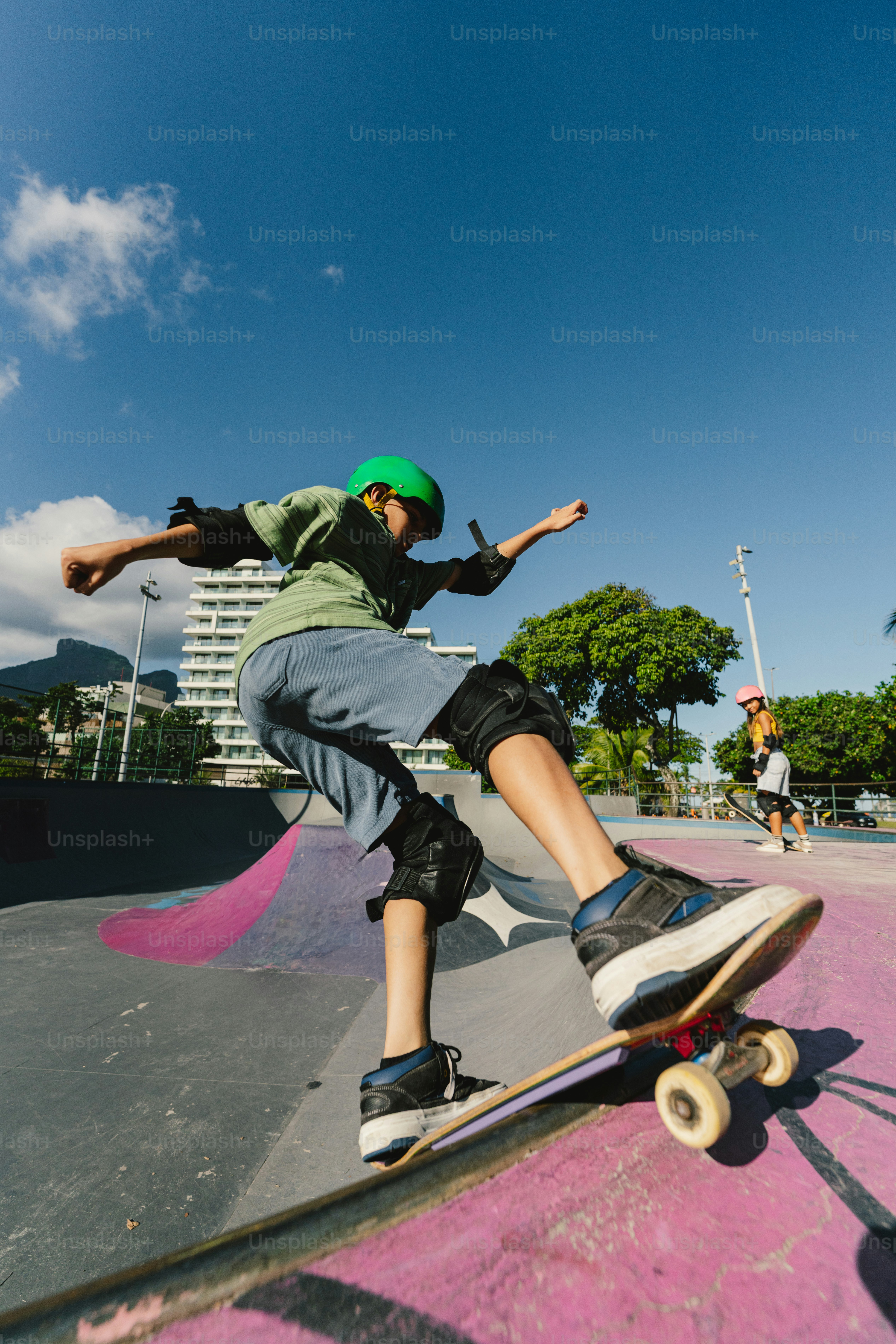 Skateboarder wearing helmet and pads in outdoor park