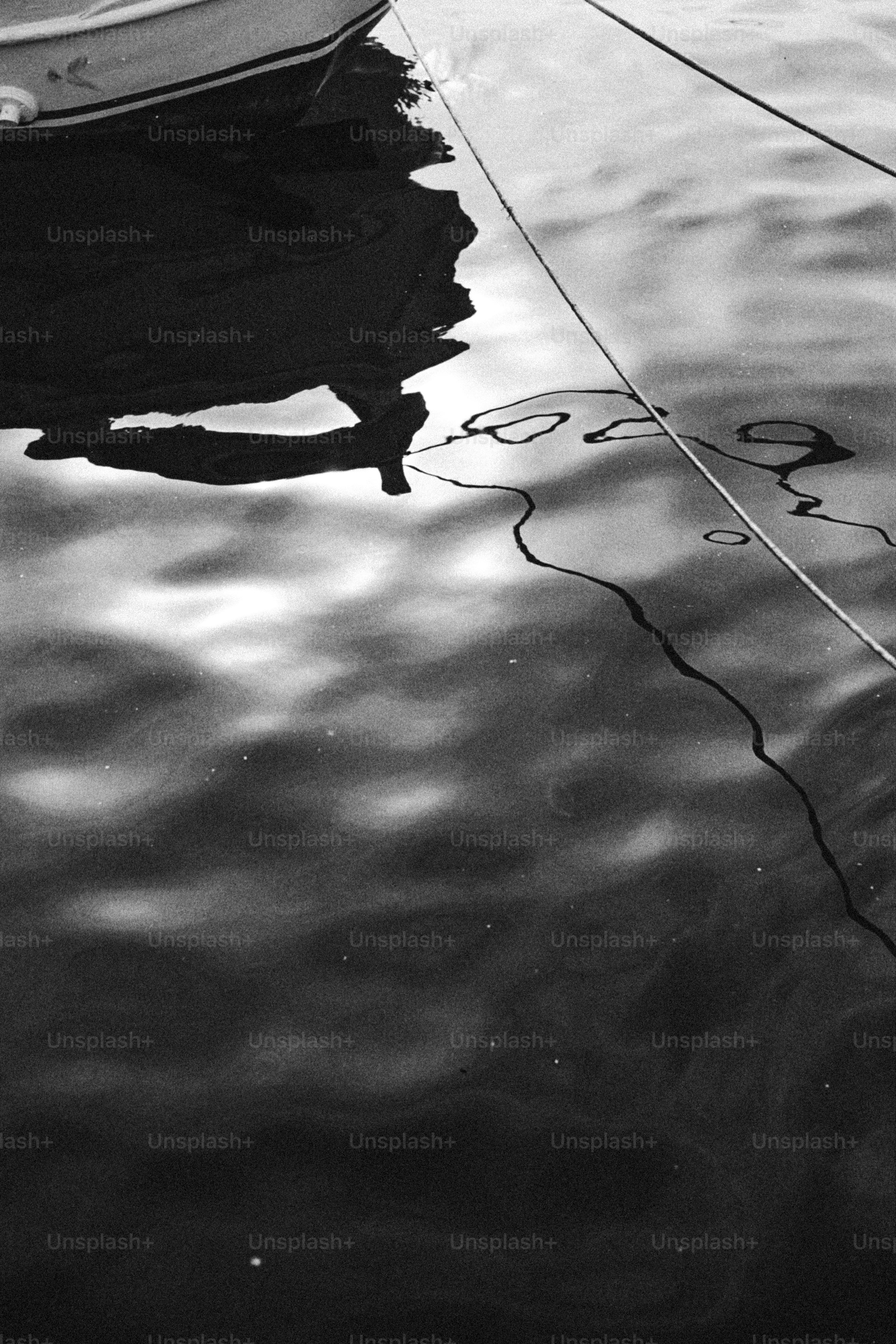 Boat reflection and mooring lines on rippling water