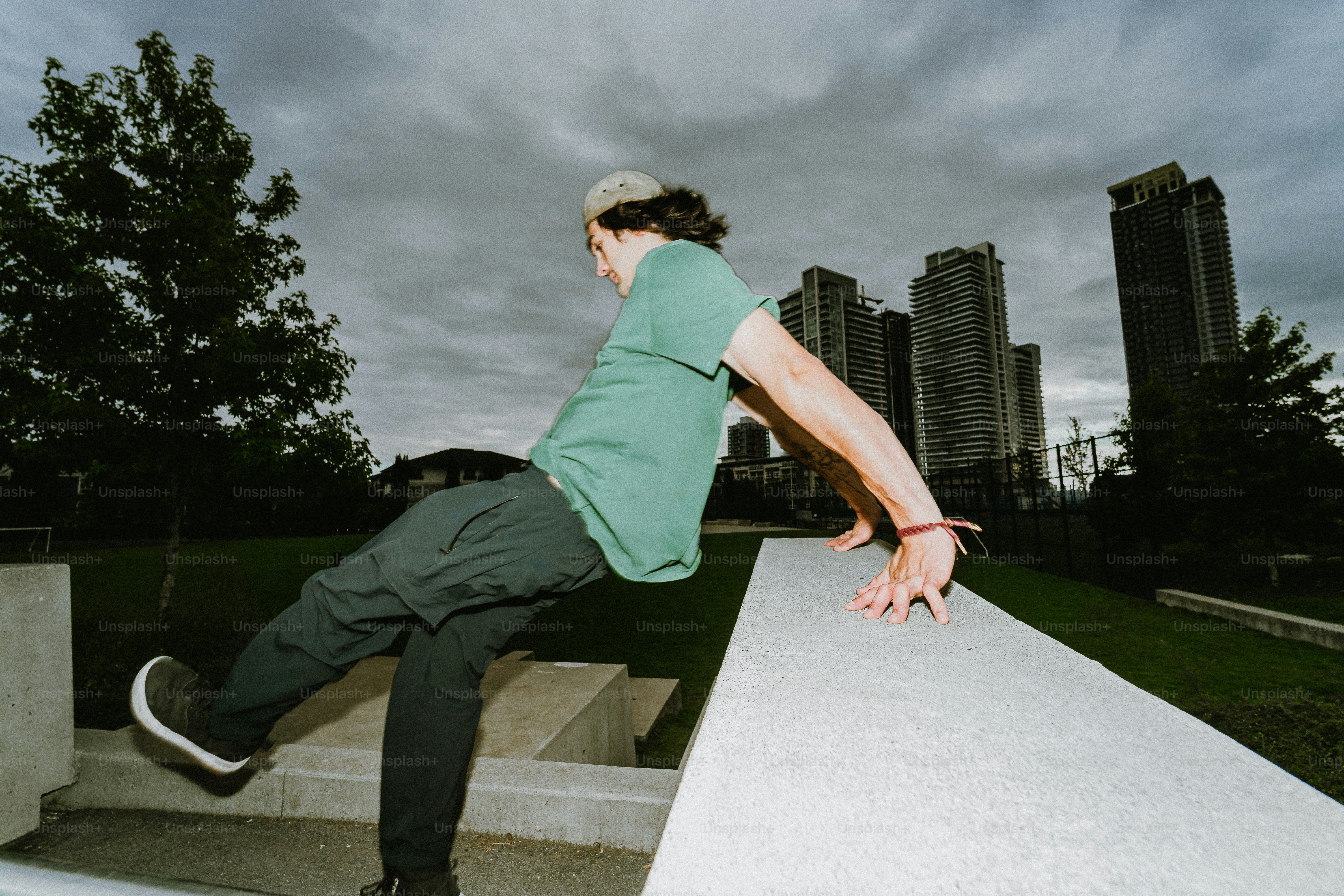 Parkour athlete vaulting concrete wall in urban area