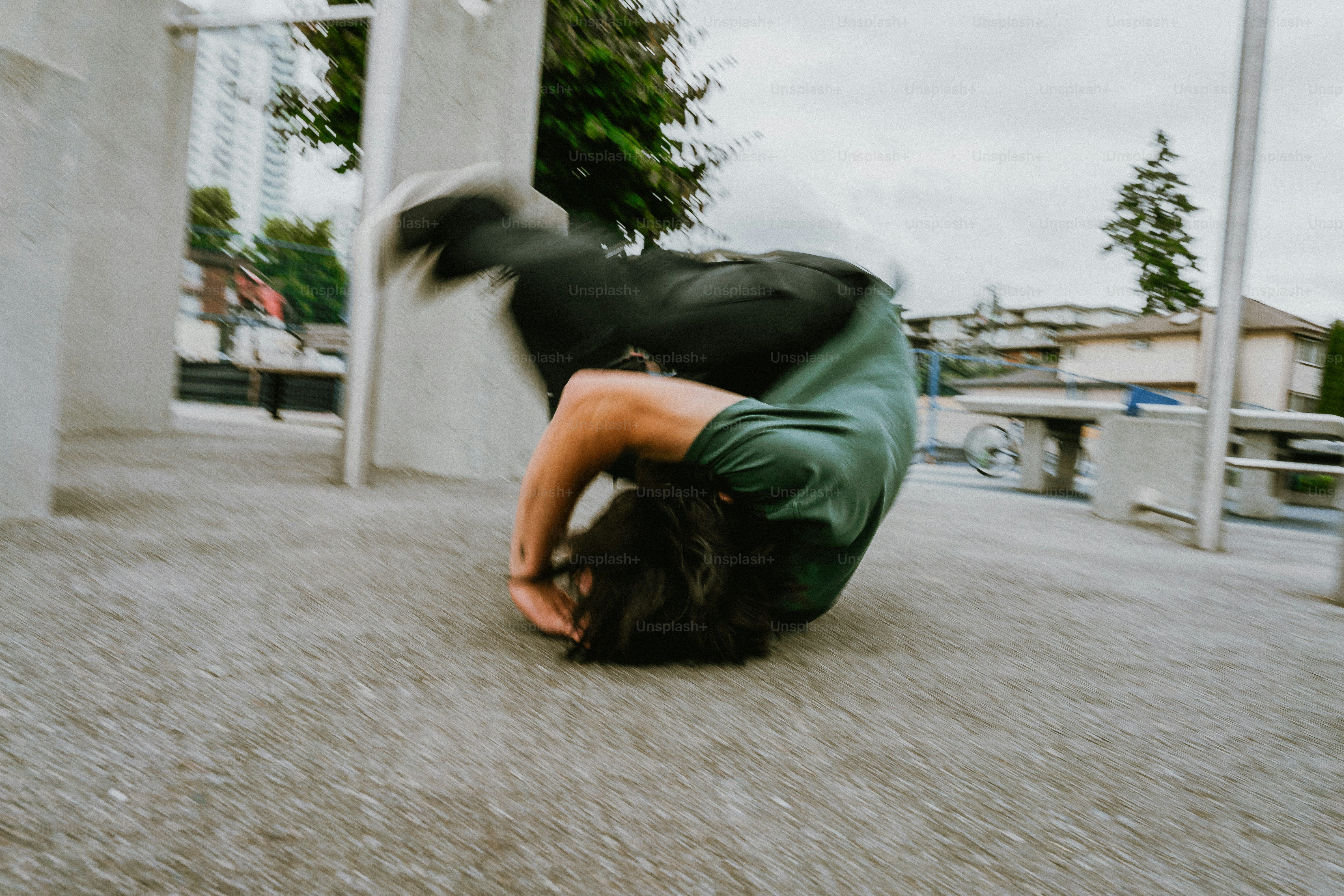 Person performing a dynamic roll on urban ground