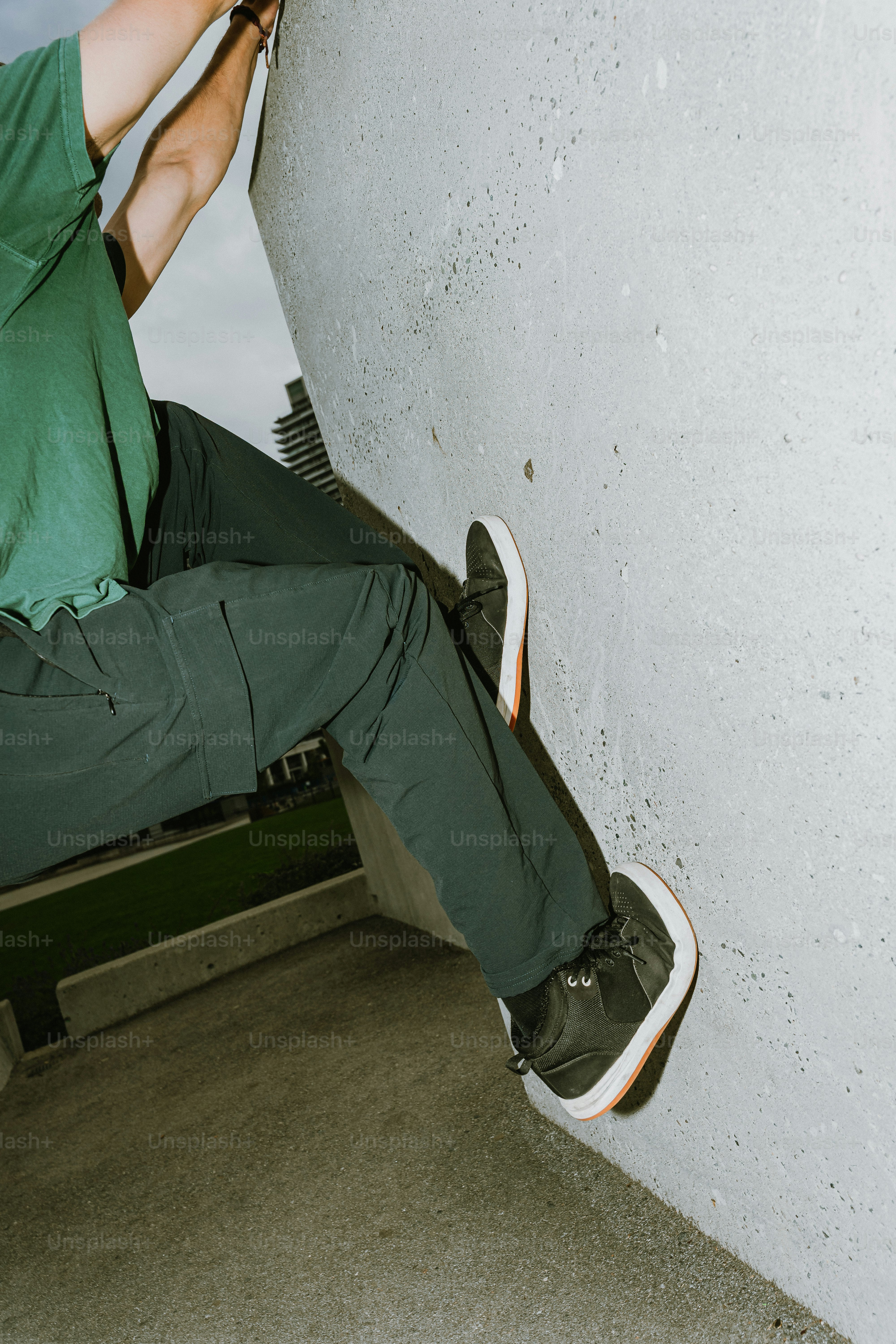 Climber scaling a concrete wall