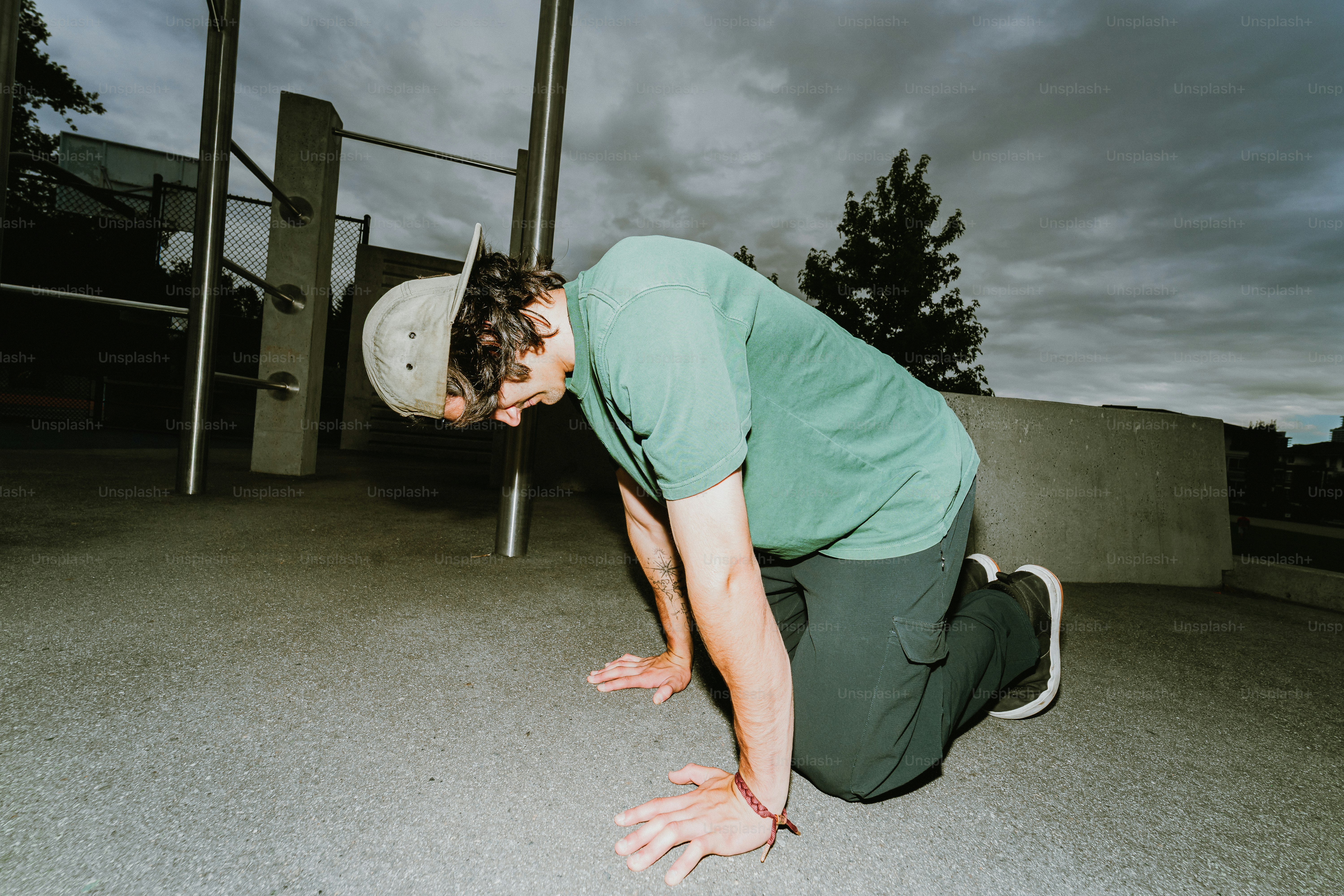 Man on hands and knees at outdoor gym