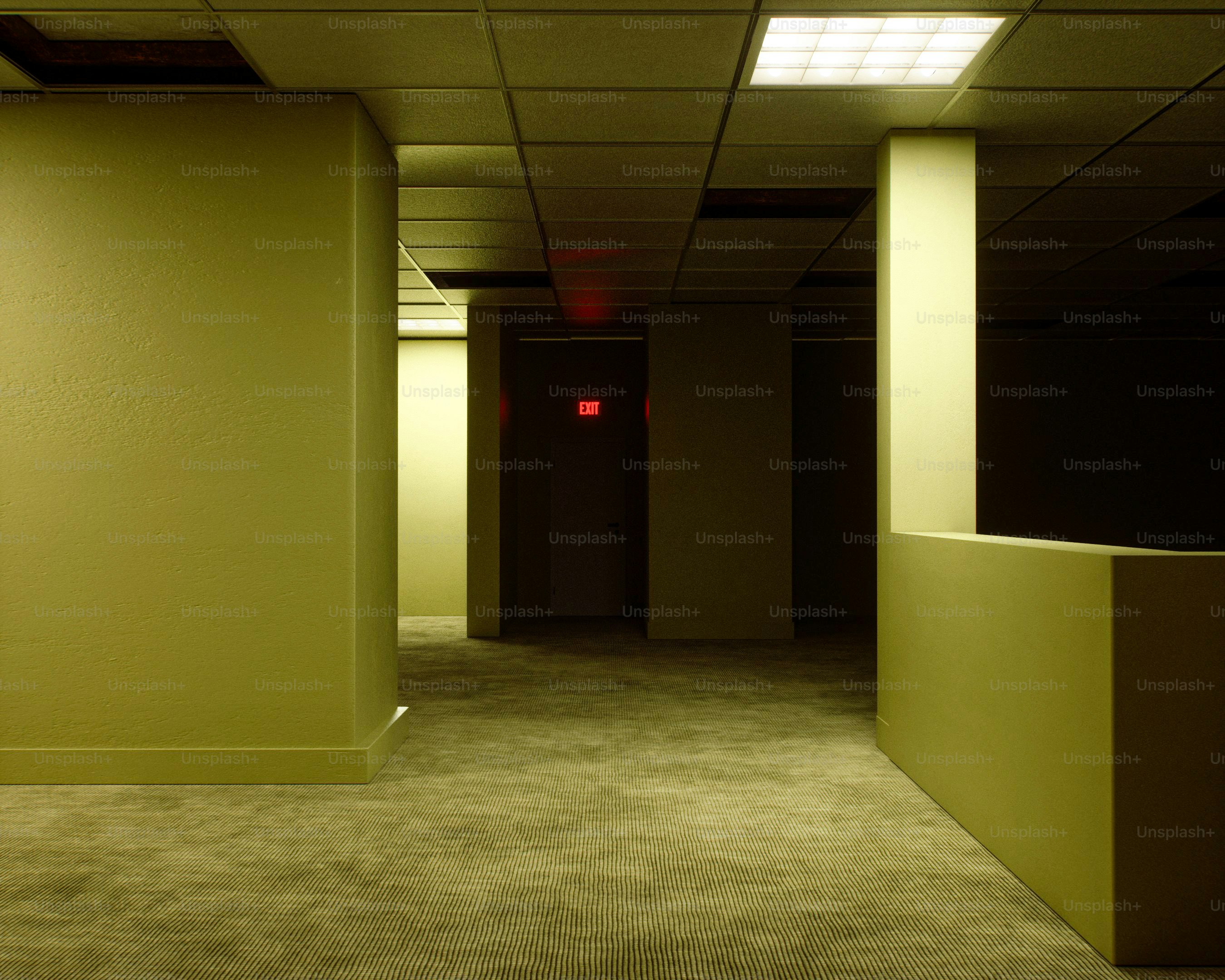 Empty office corridor with dim fluorescent lighting
