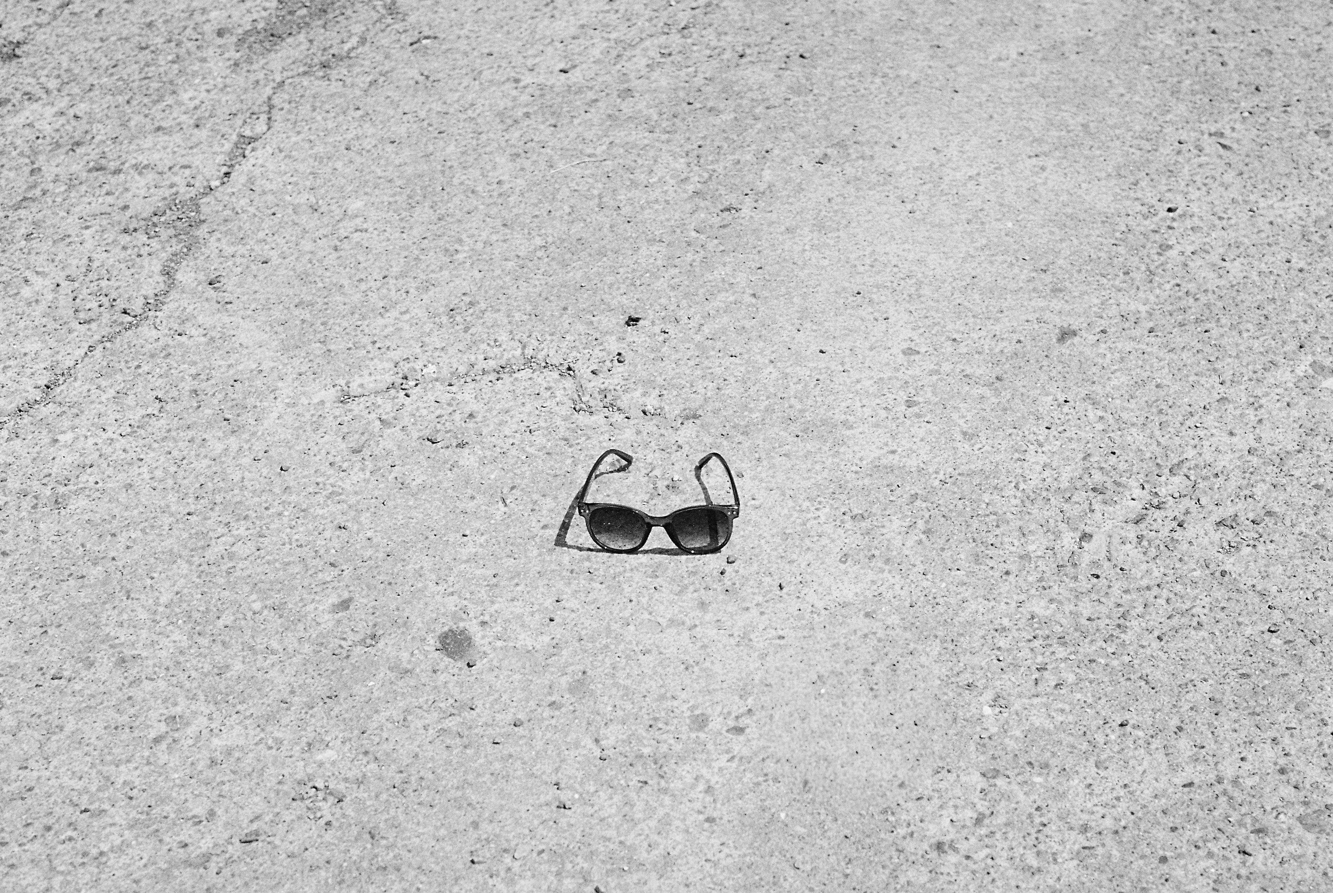 Black sunglasses on textured concrete surface