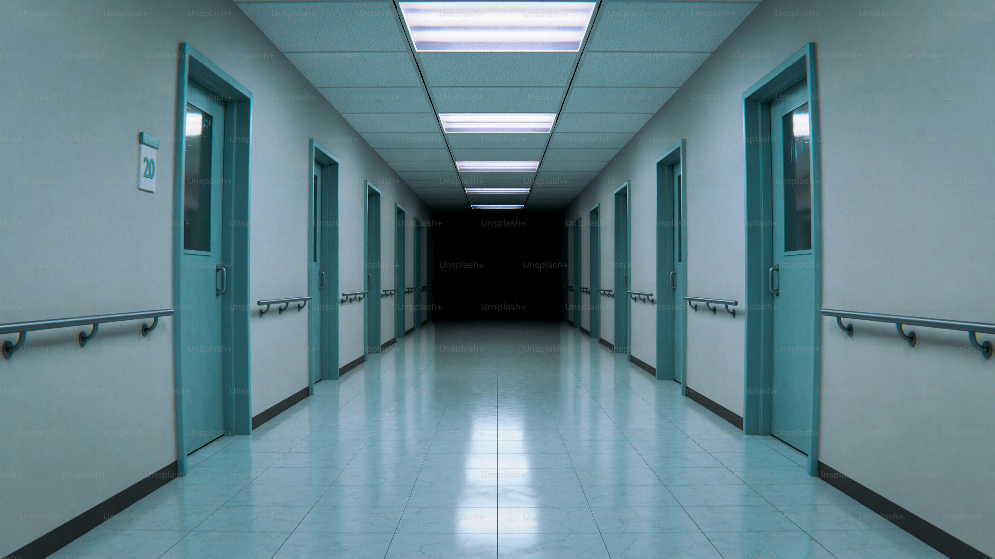 Long hospital hallway with doors and dark end