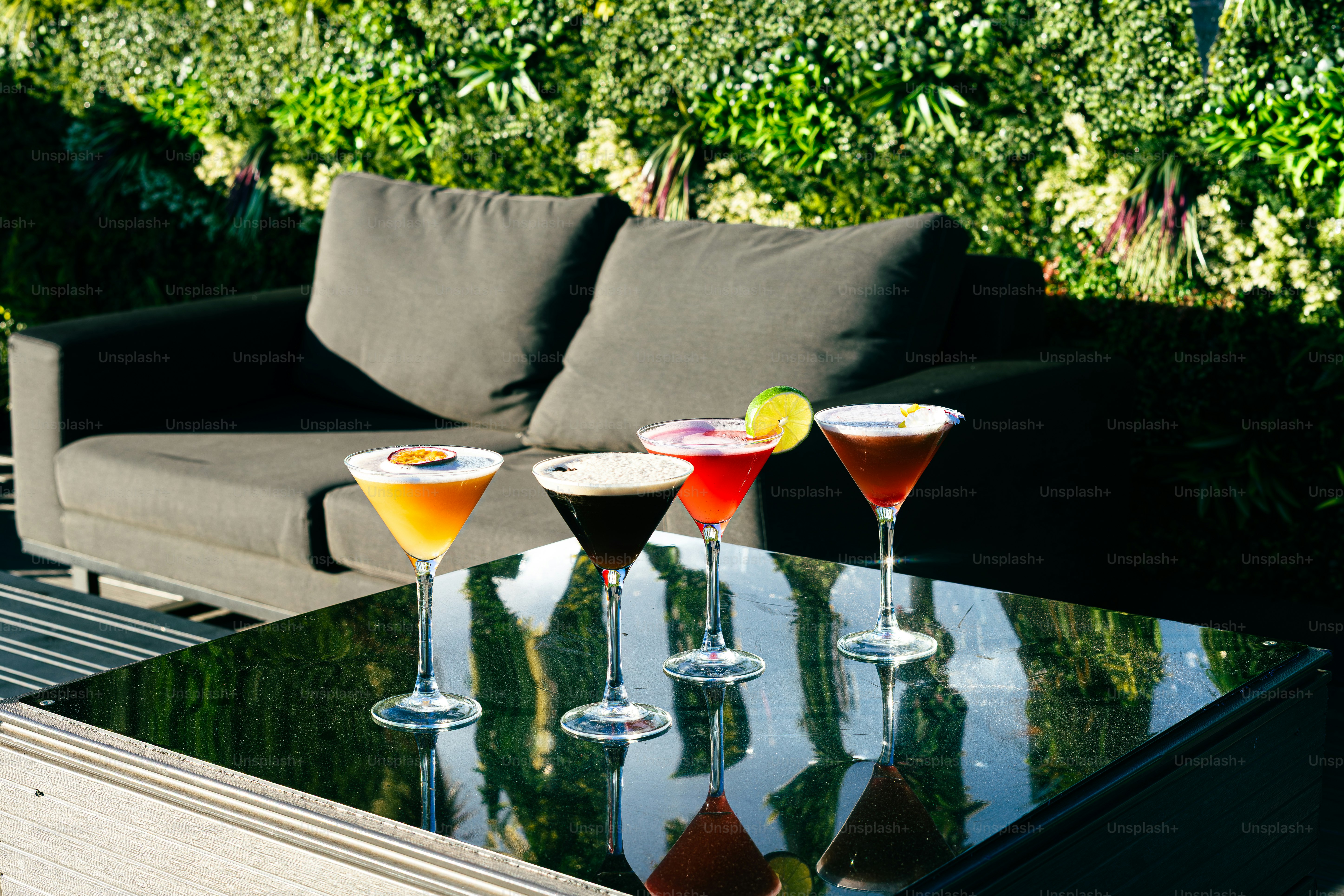 Colorful summer cocktails on outdoor glass table