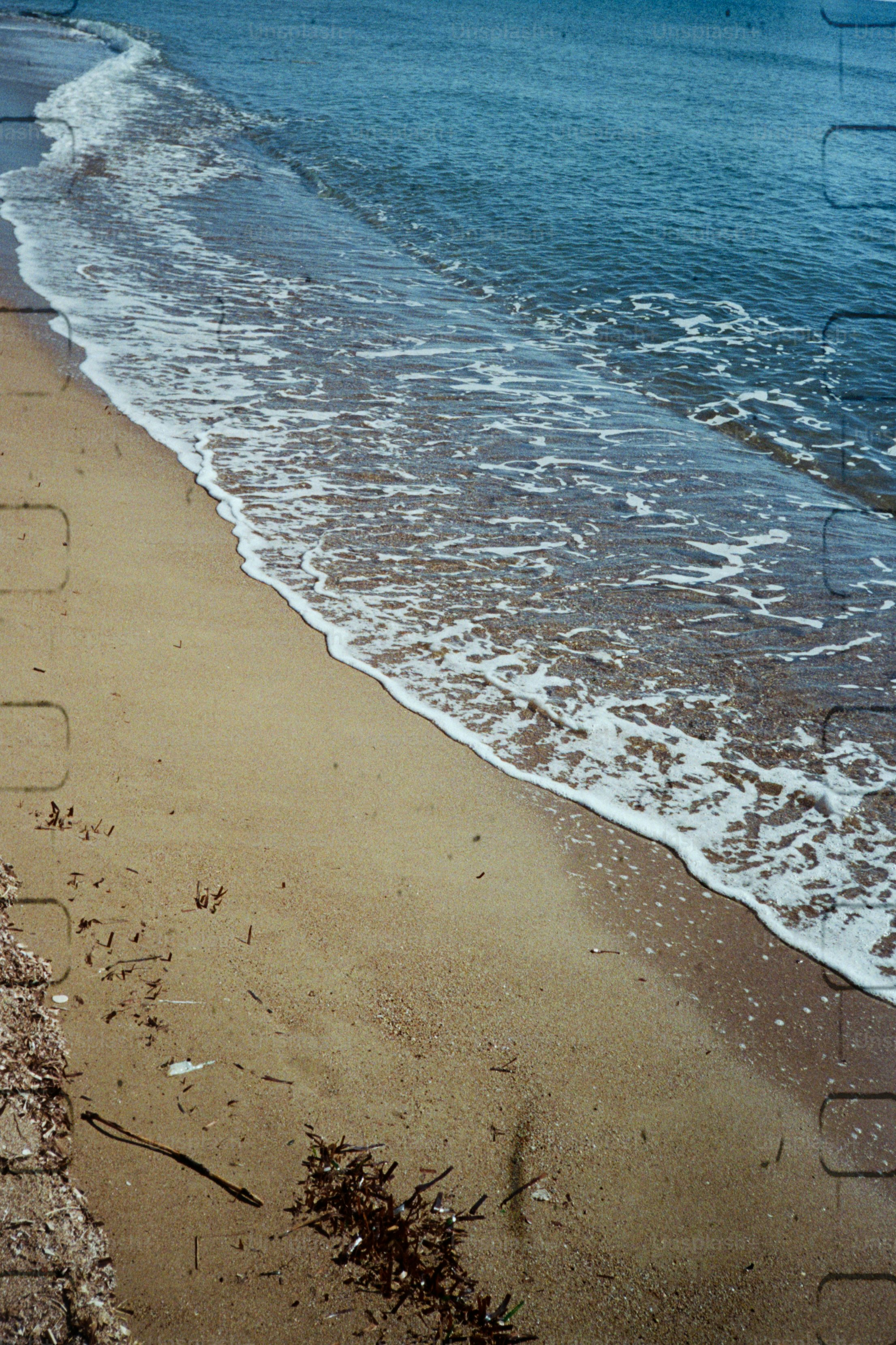 Waves washing ashore on a sandy beach