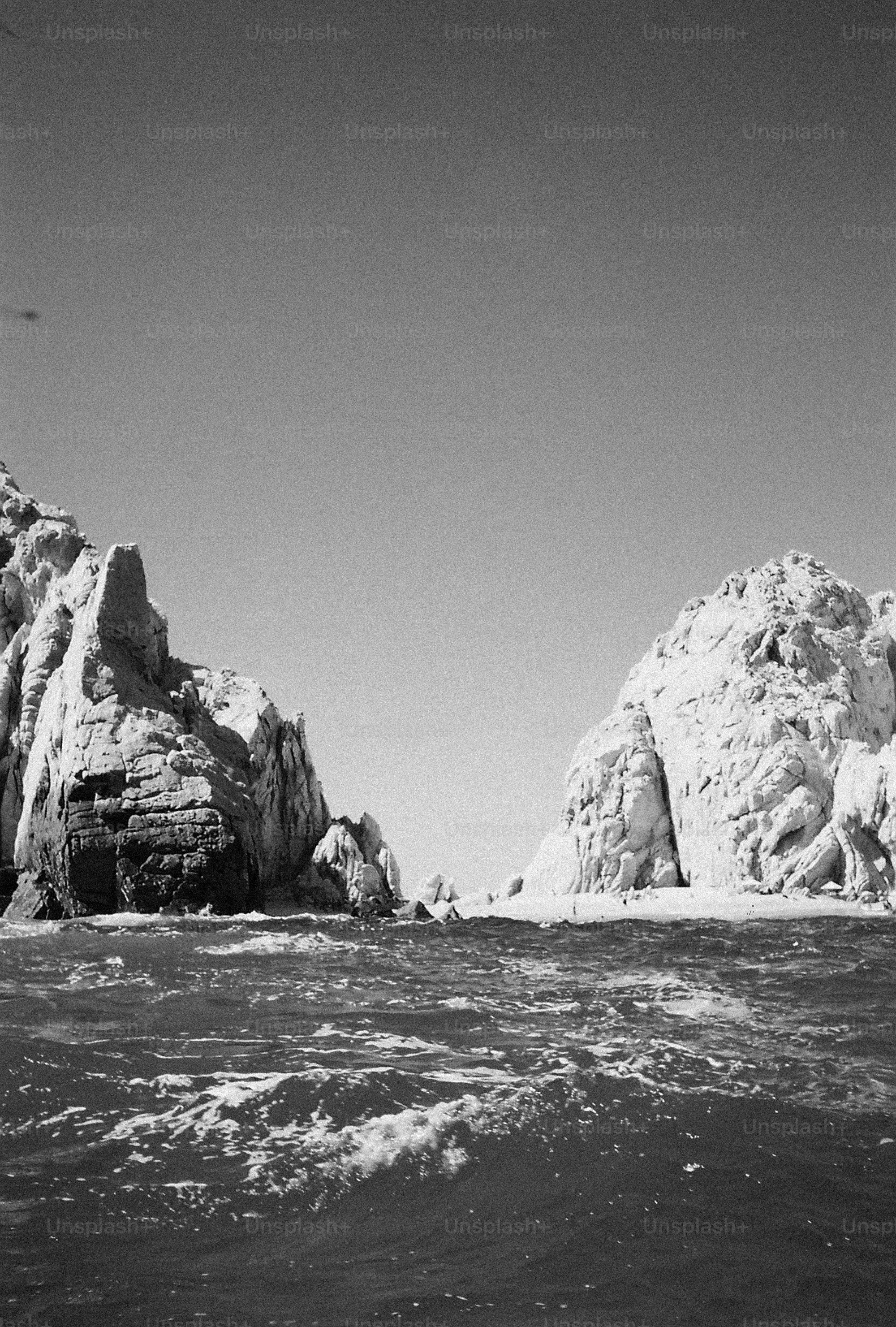Ocean waves between towering rock formations