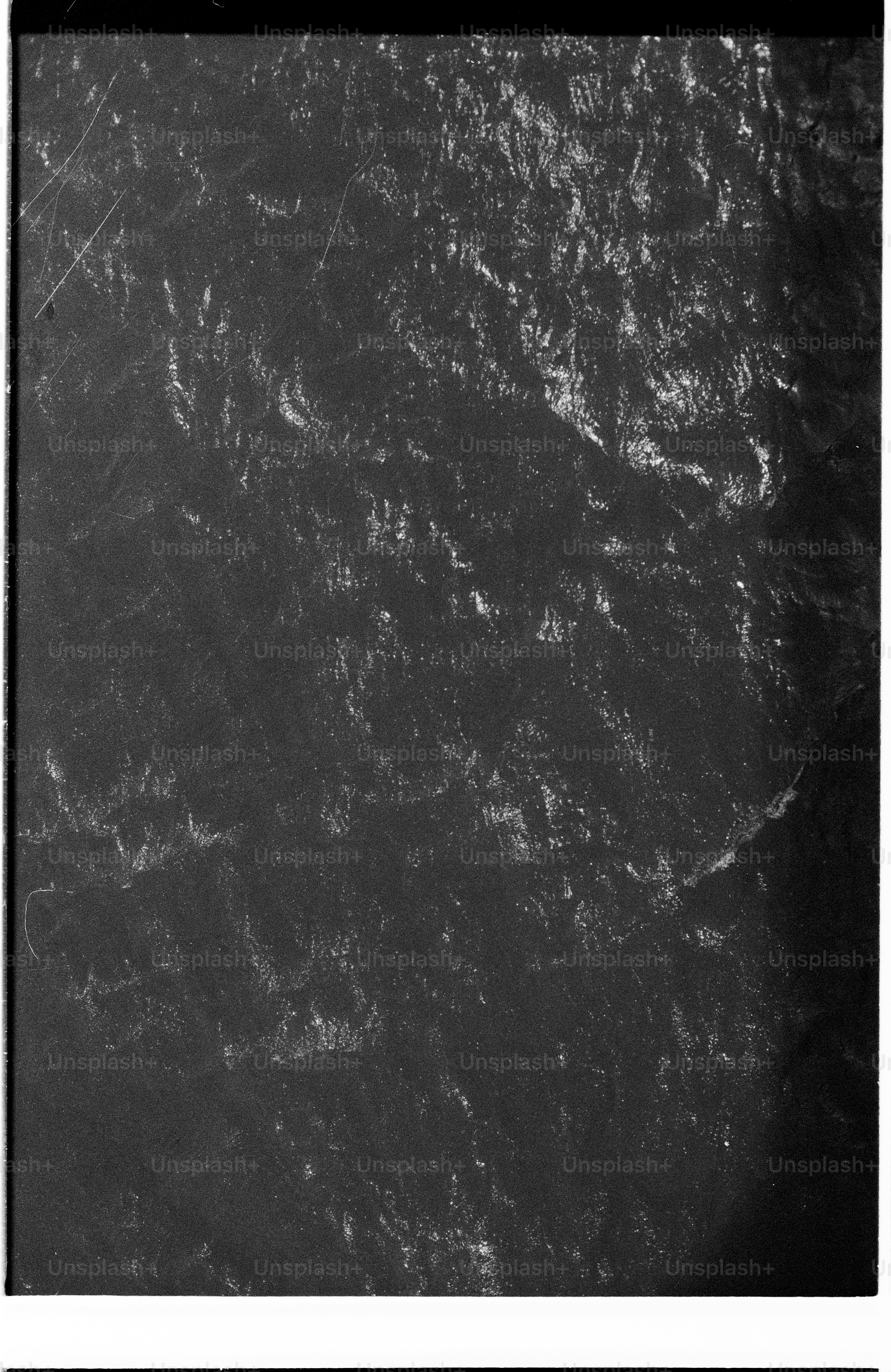 Distressed black and white texture with light scratches