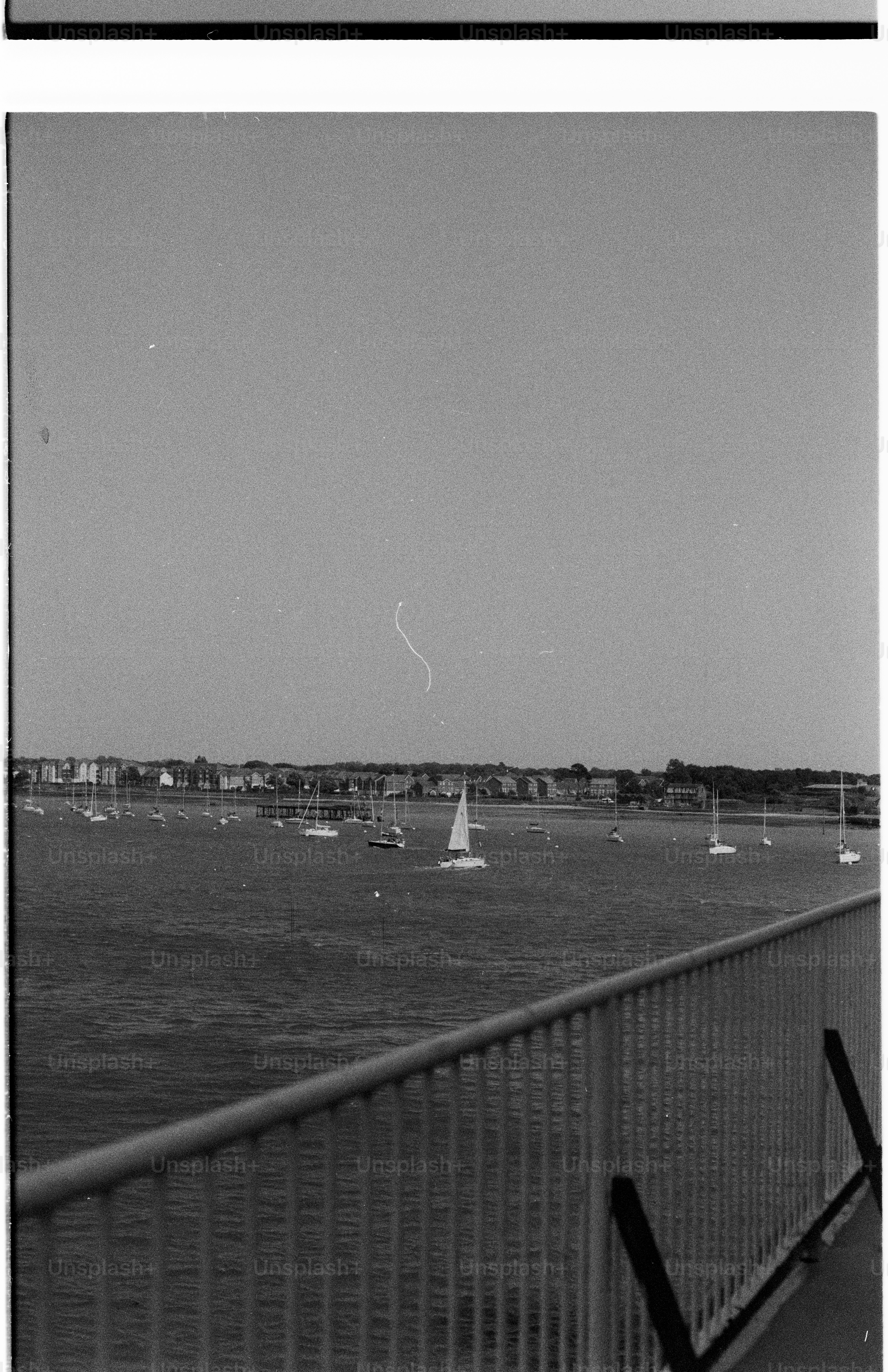 Boats in harbor from bridge railing