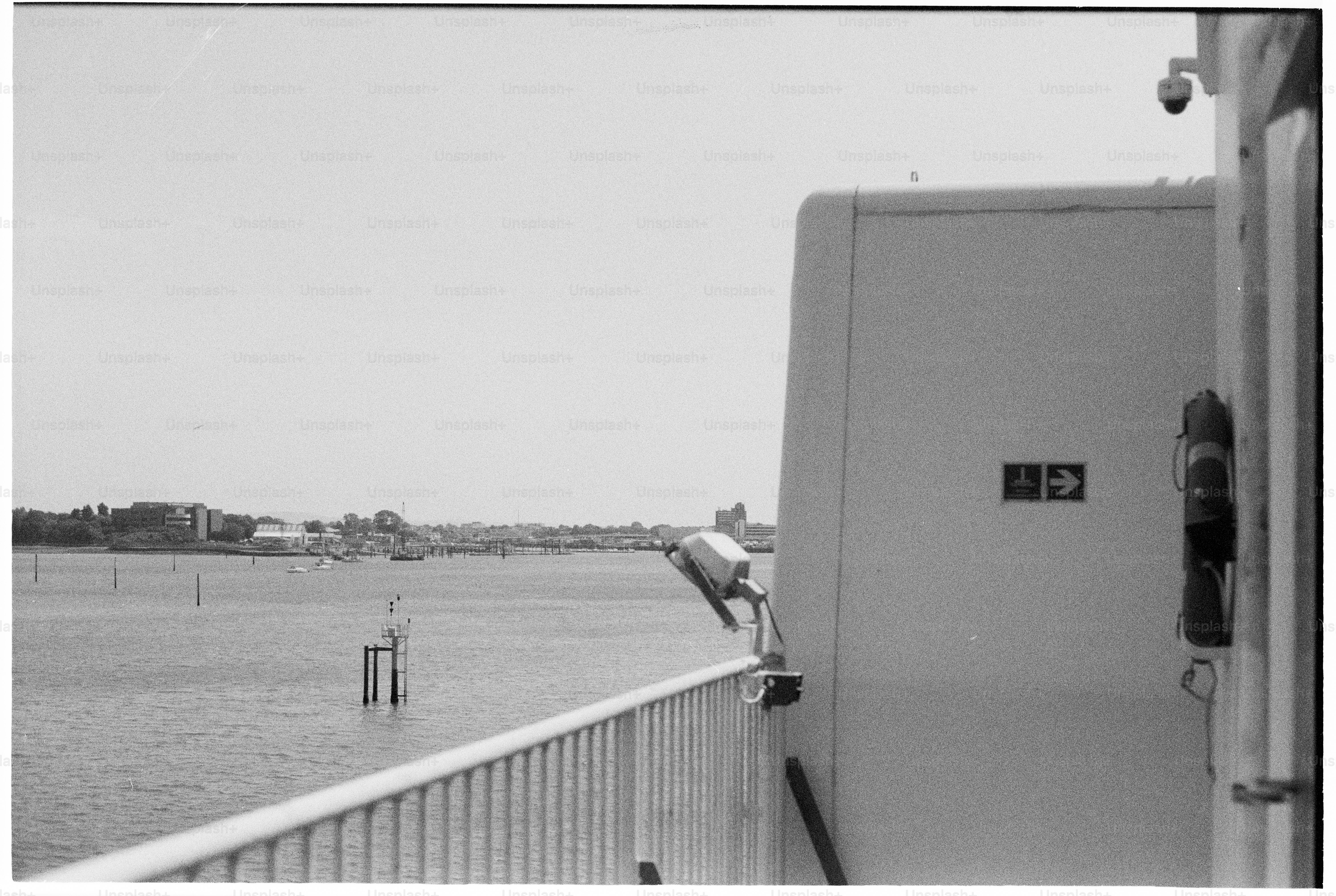 Black and white boat railing overlooking water and land