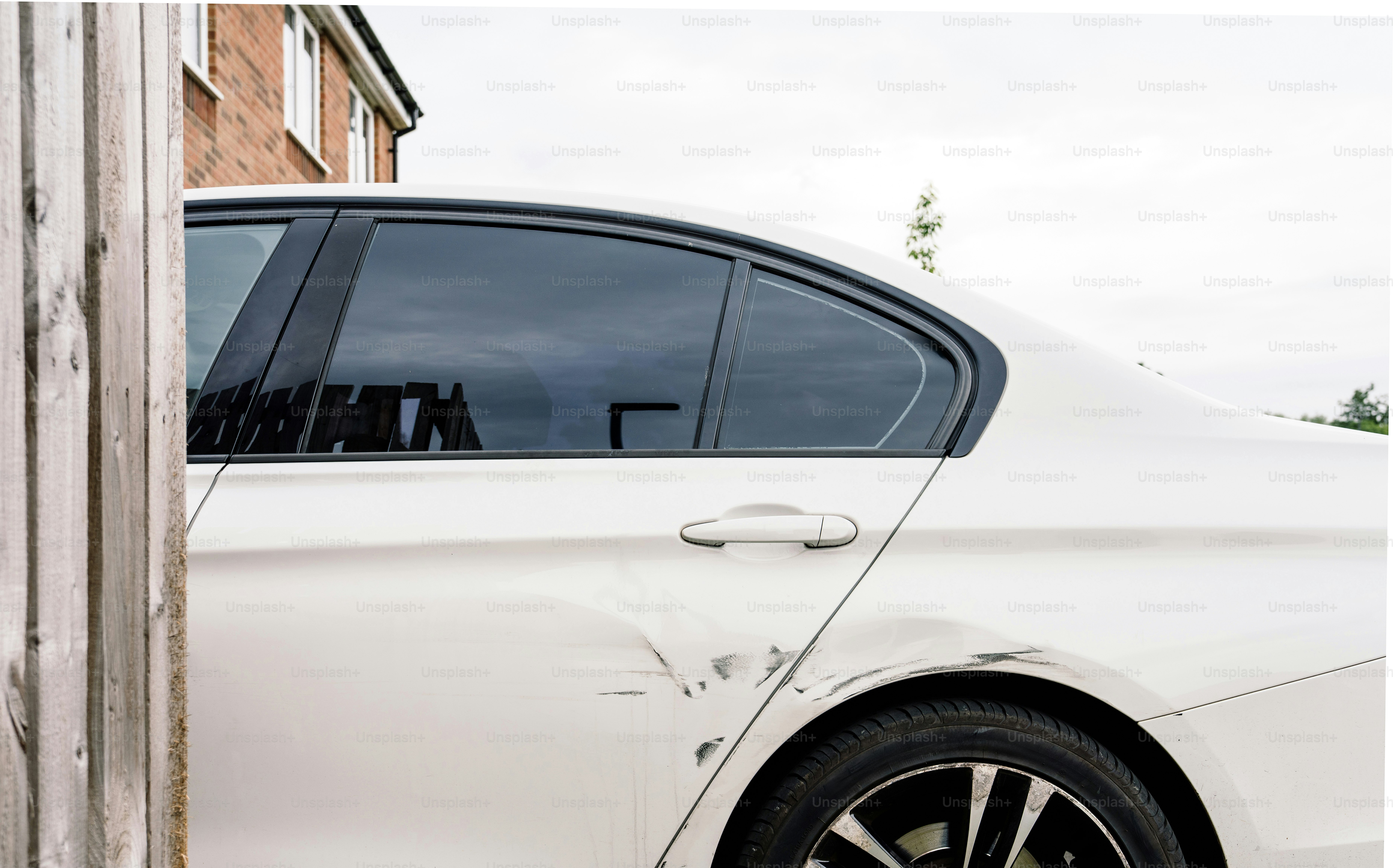 White car with significant side body damage