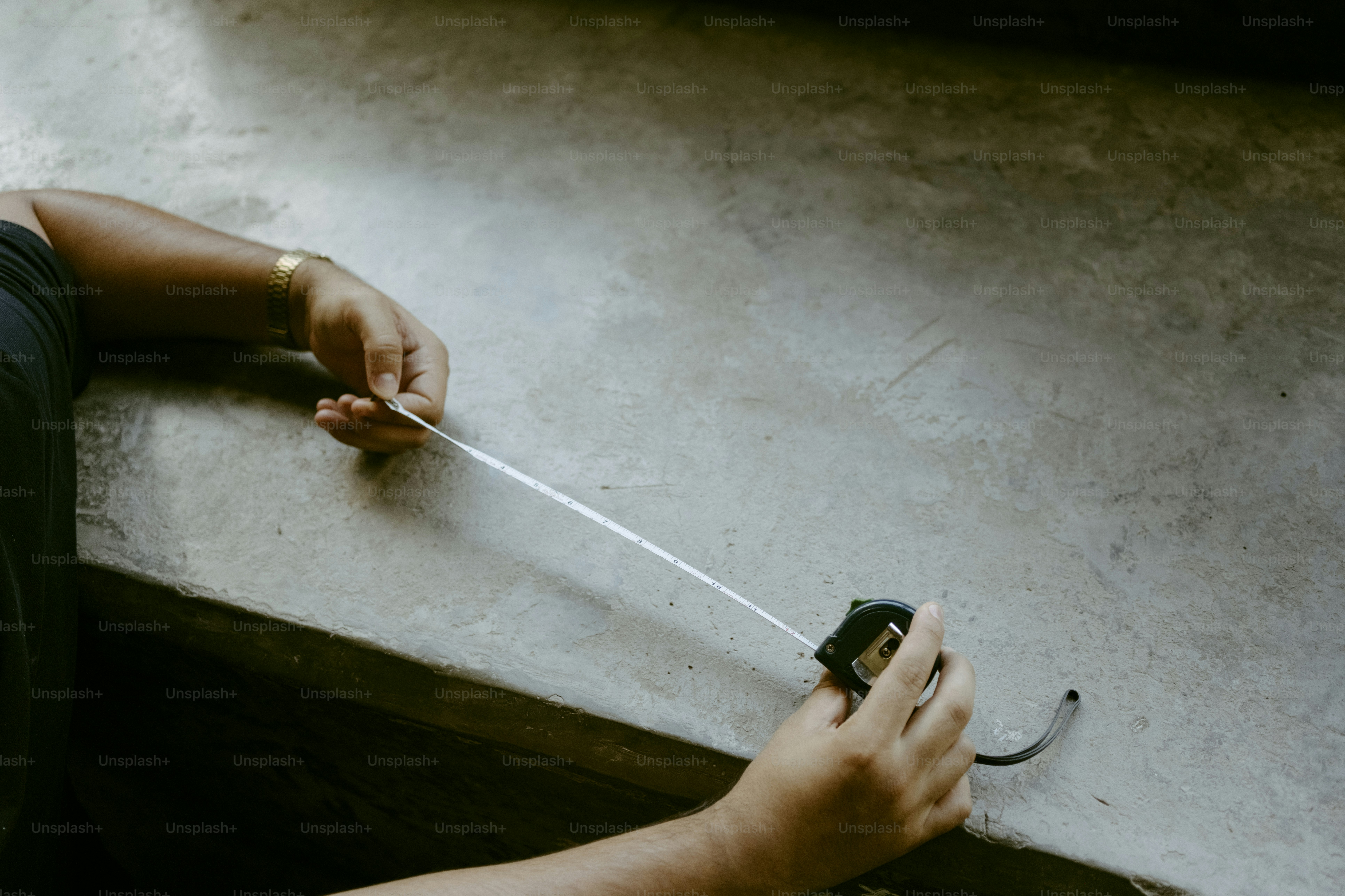Hands holding white line from measuring device