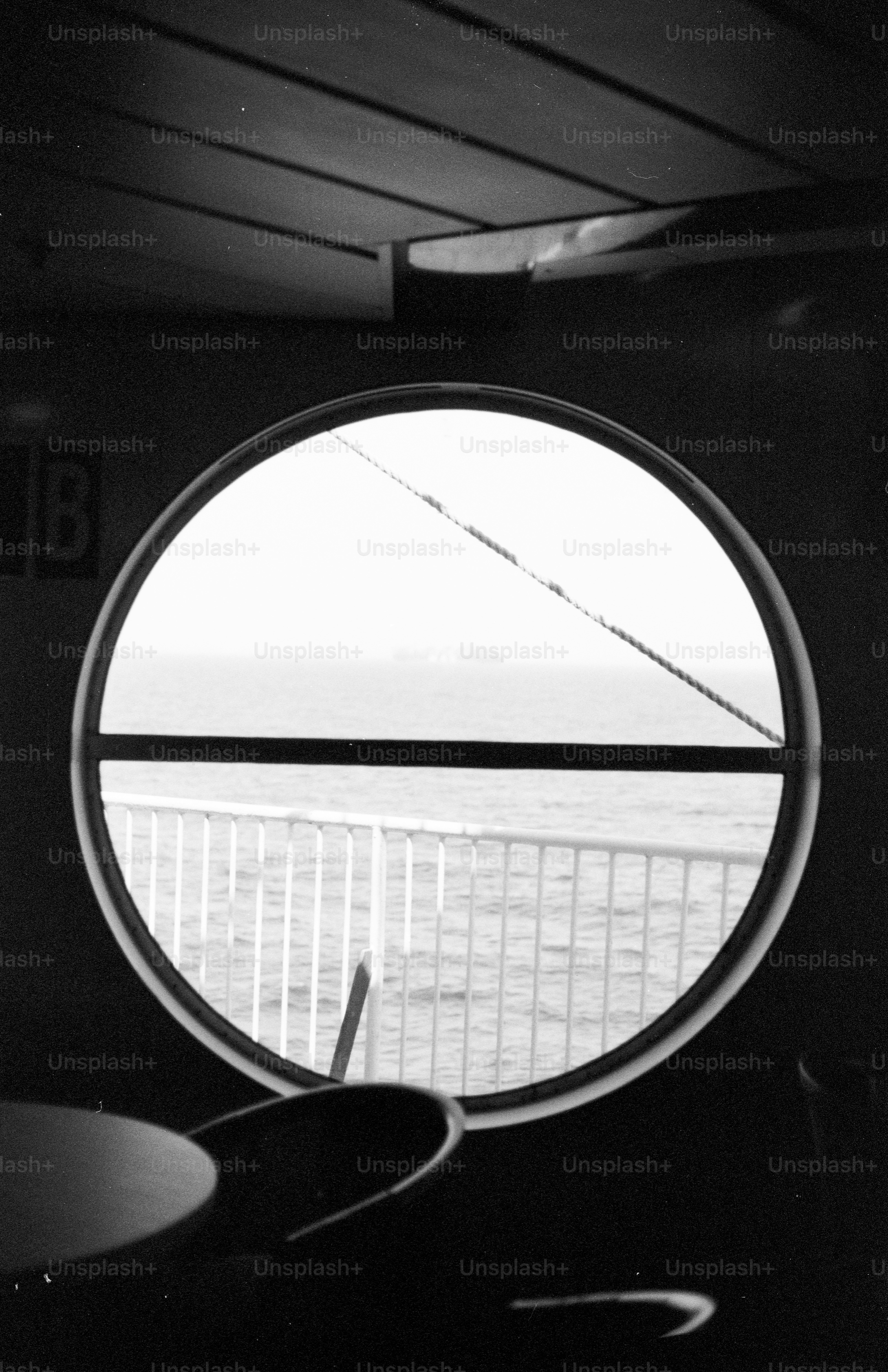 Ship's porthole overlooking ocean and railing