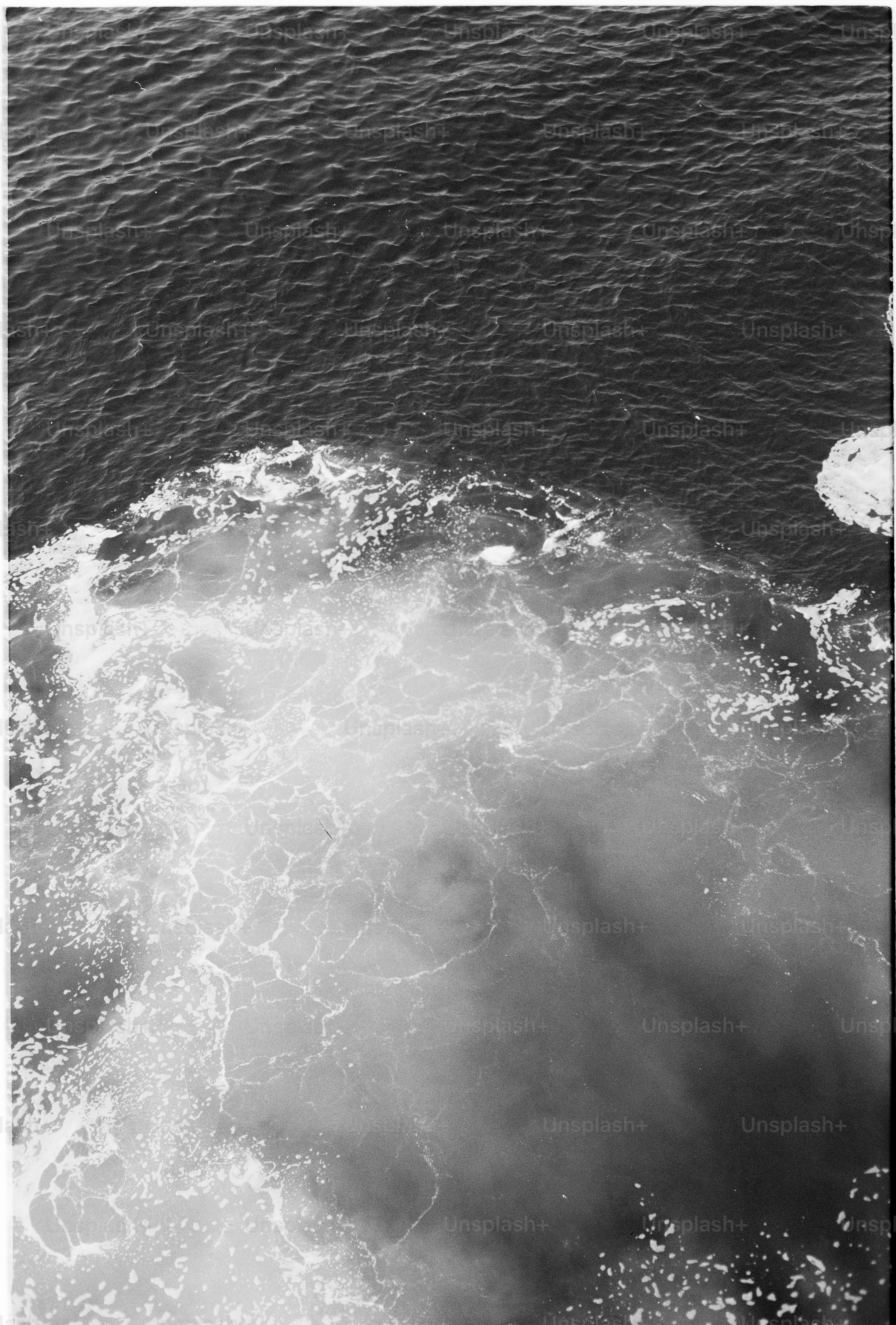 Churning ocean water creating white foam