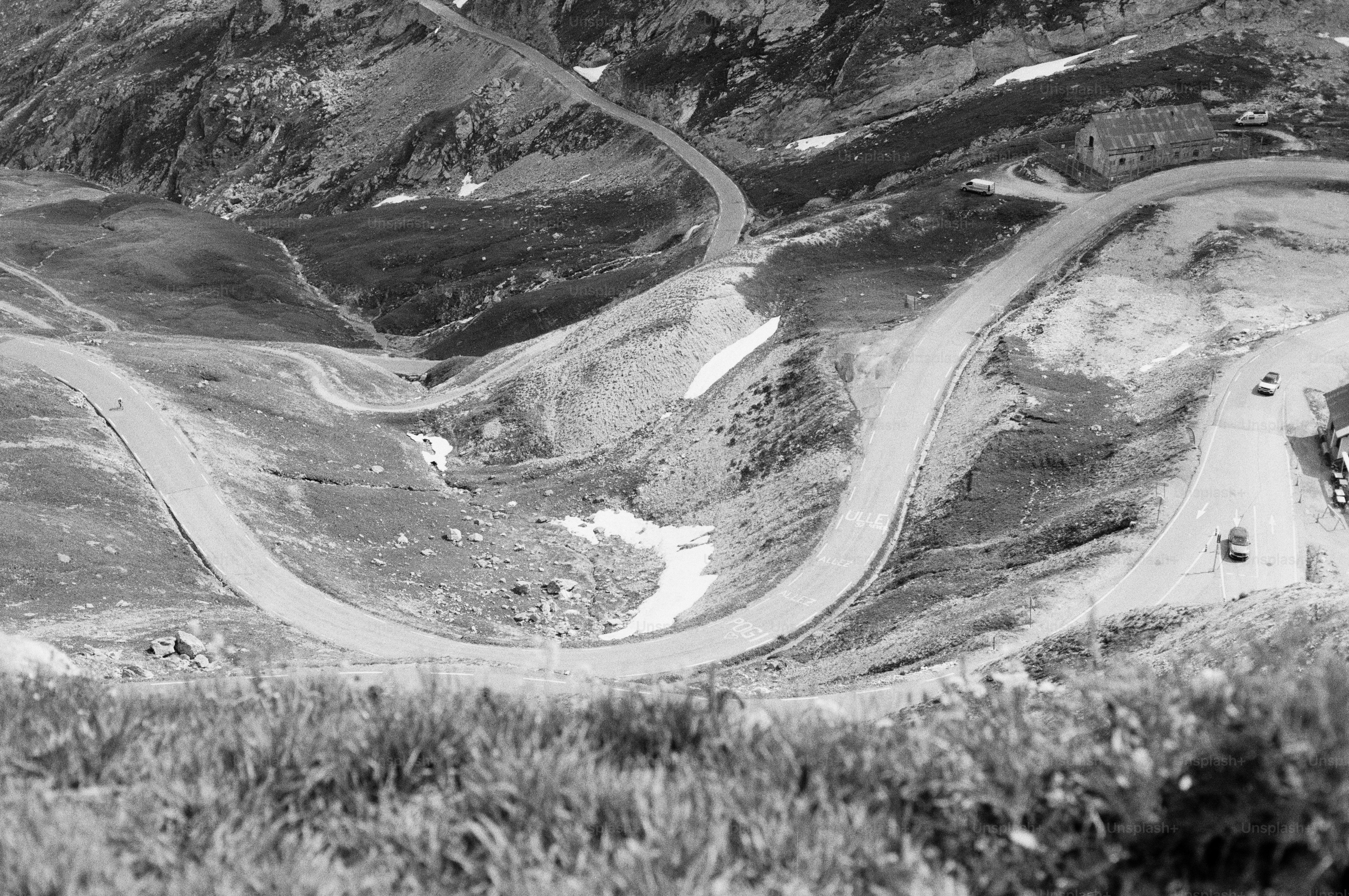 Winding road through barren mountain landscape with snow