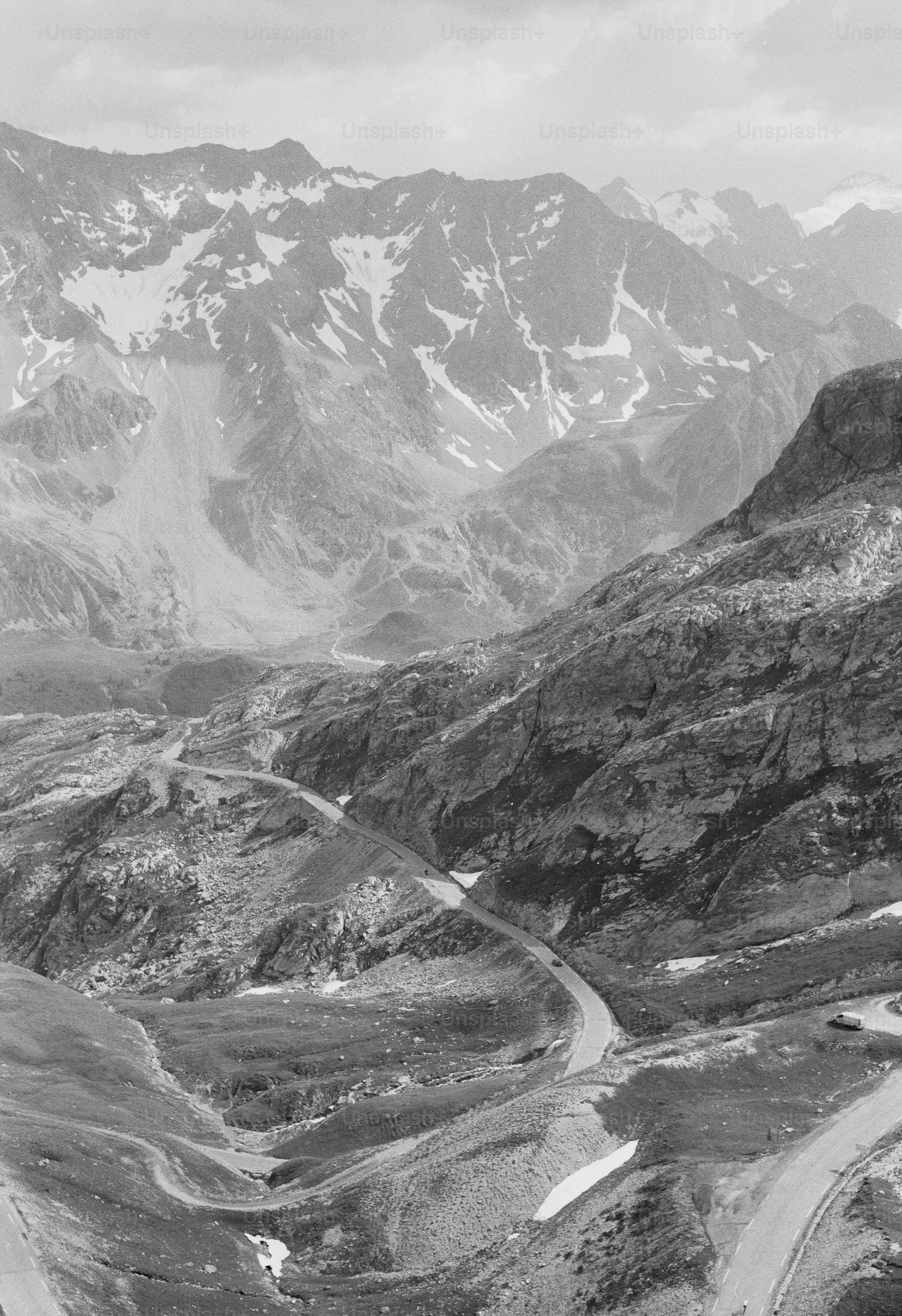 Black and white winding road through snowy mountains