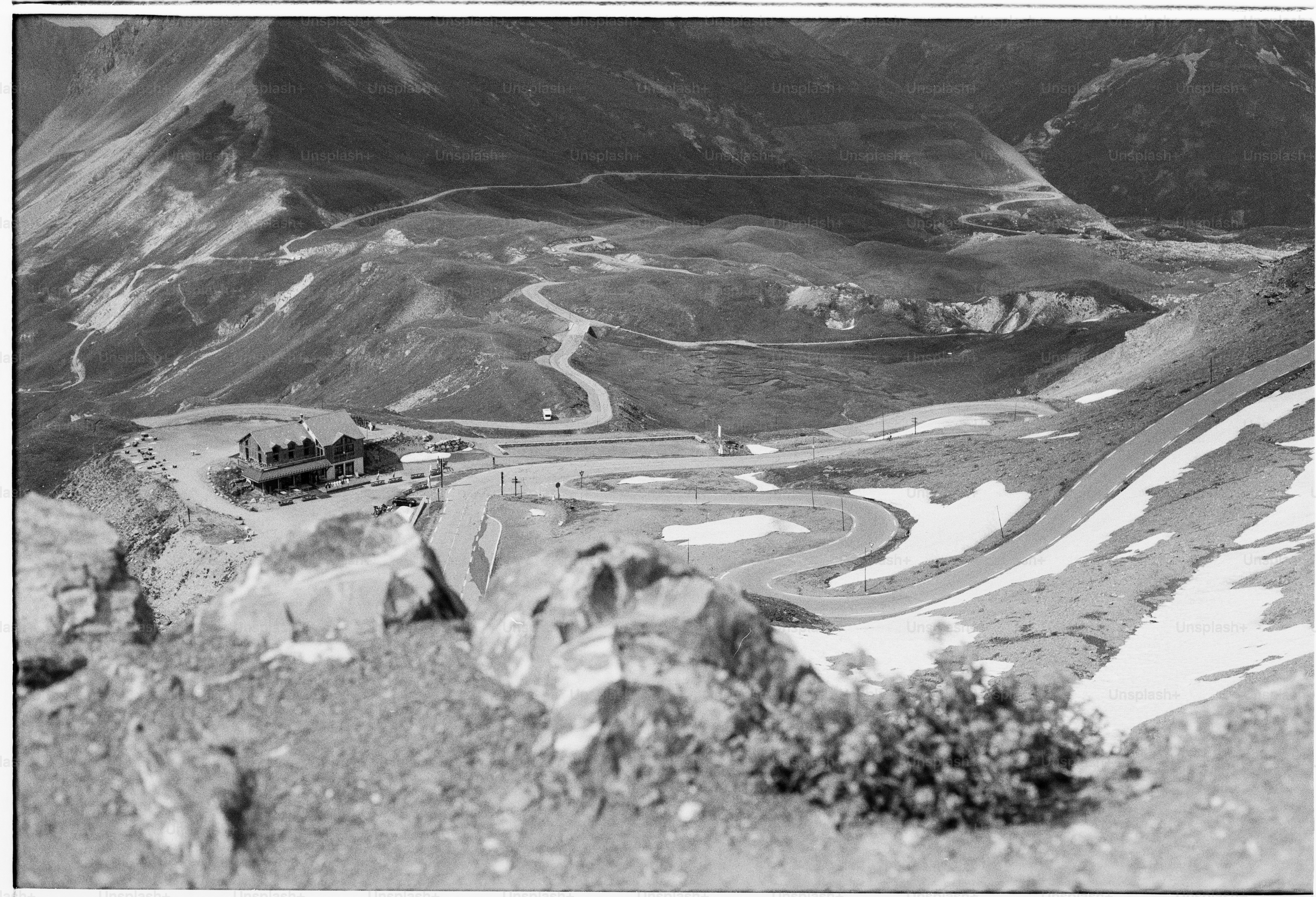 Mountain pass with winding road and building complex