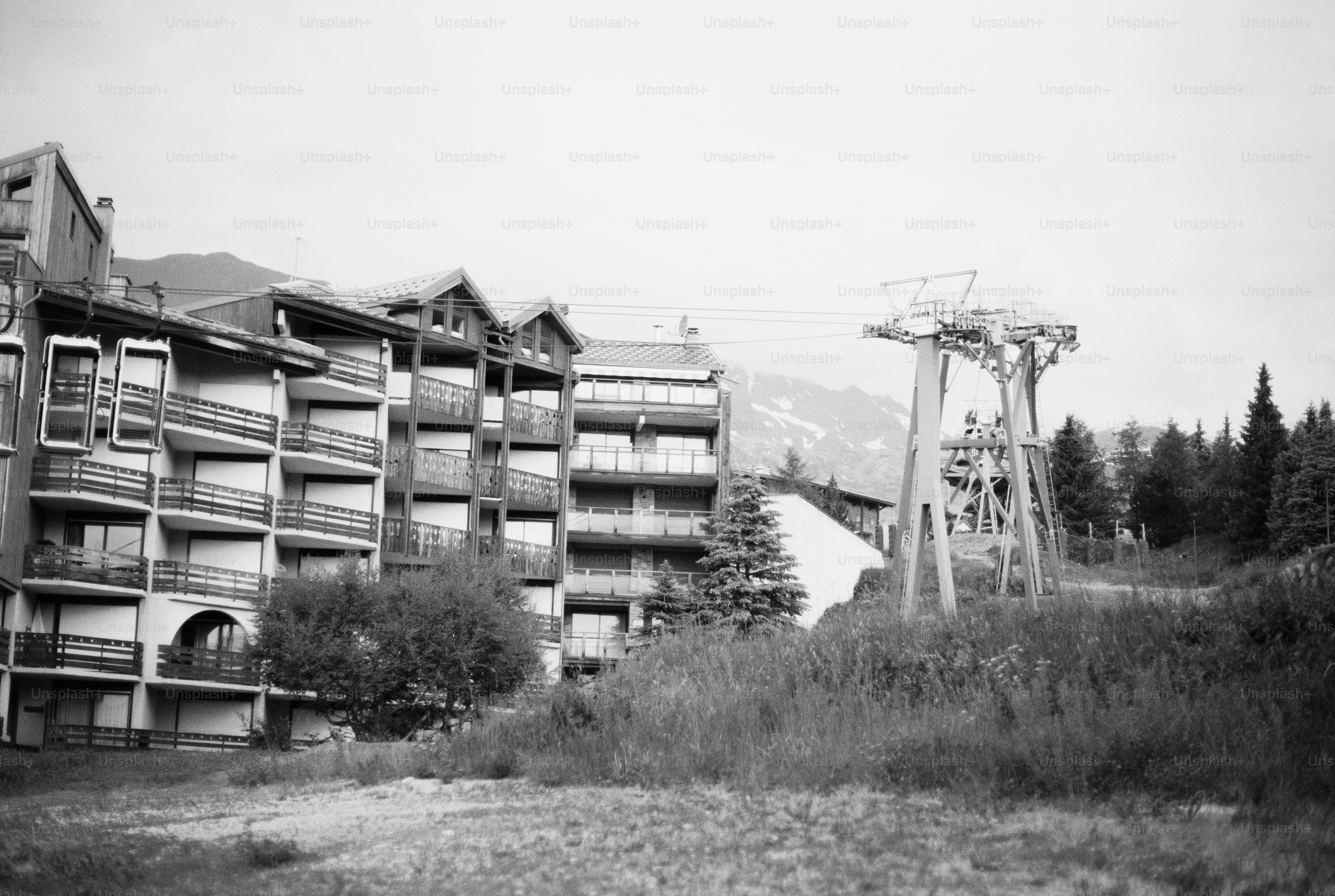 Black and white ski resort buildings and lift tower