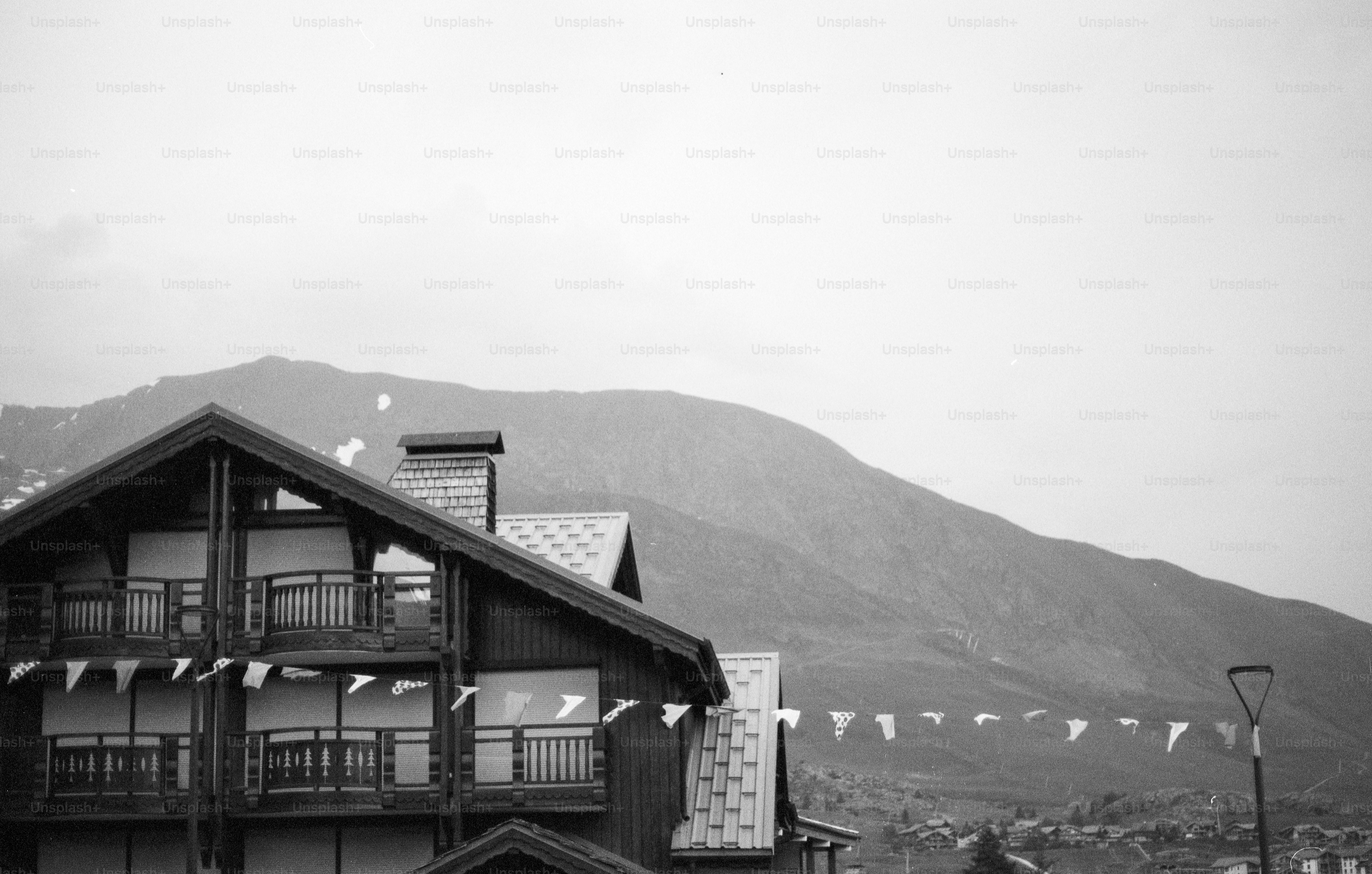 Alpine lodge with mountain and string of flags